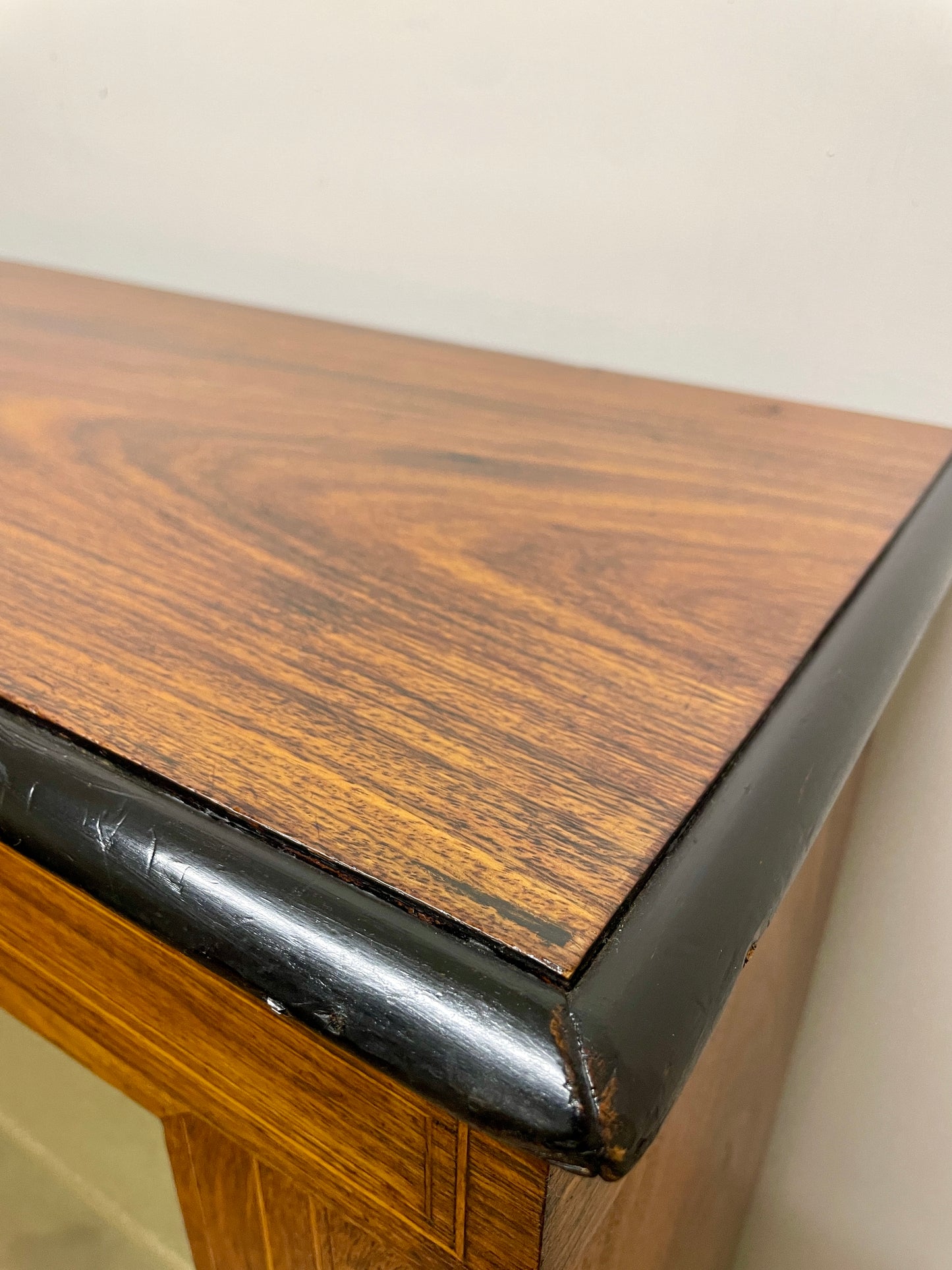 Wooden surface with a black trim on a neutral background