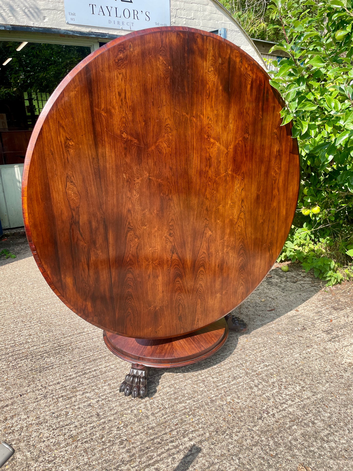 Wooden round table outdoors with a blurred background