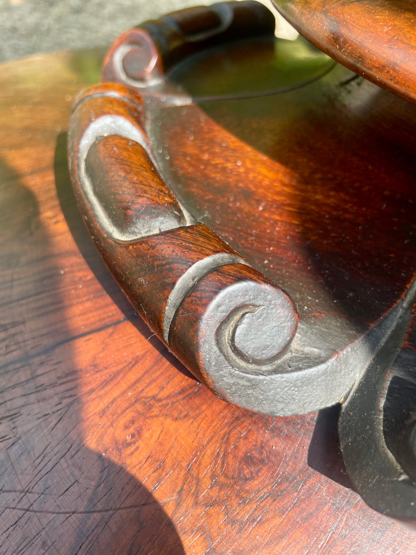 Wooden handle with metal accents on a wooden surface