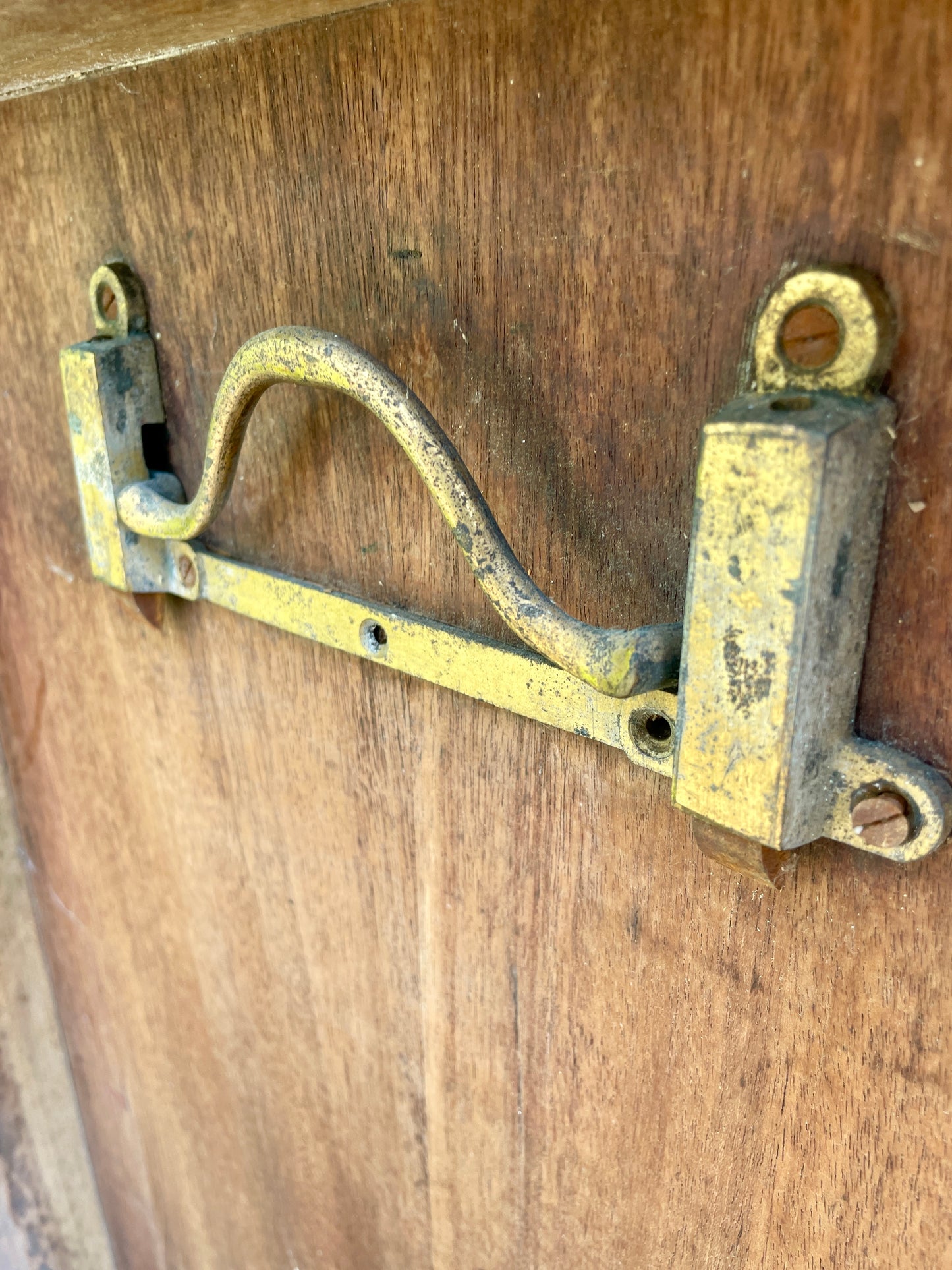 Vintage brass latch on a wooden surface