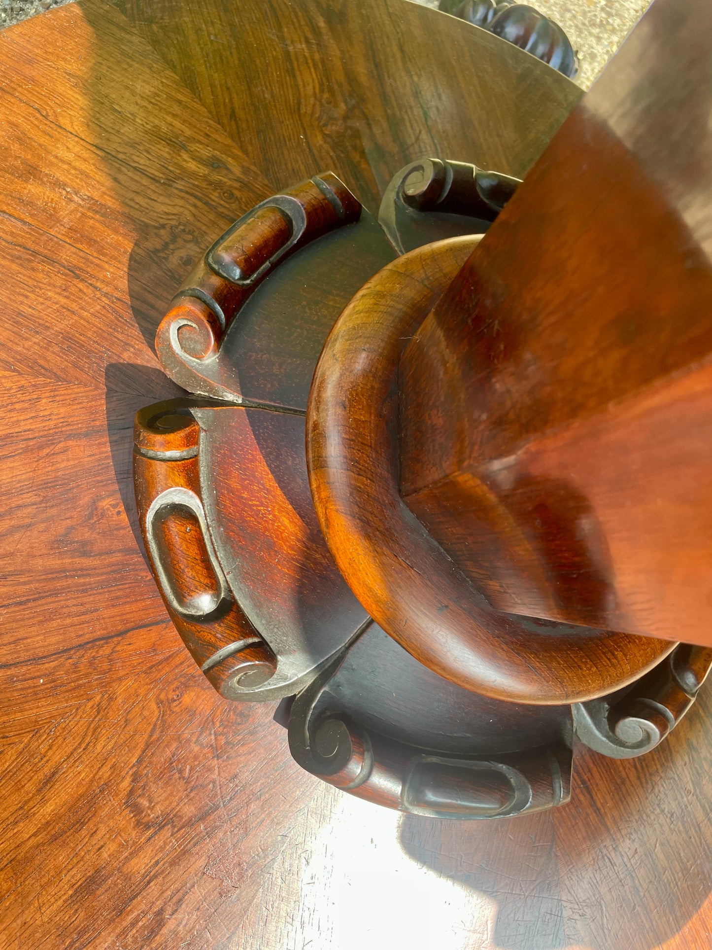 Wooden bowl with metal straps on a wooden surface