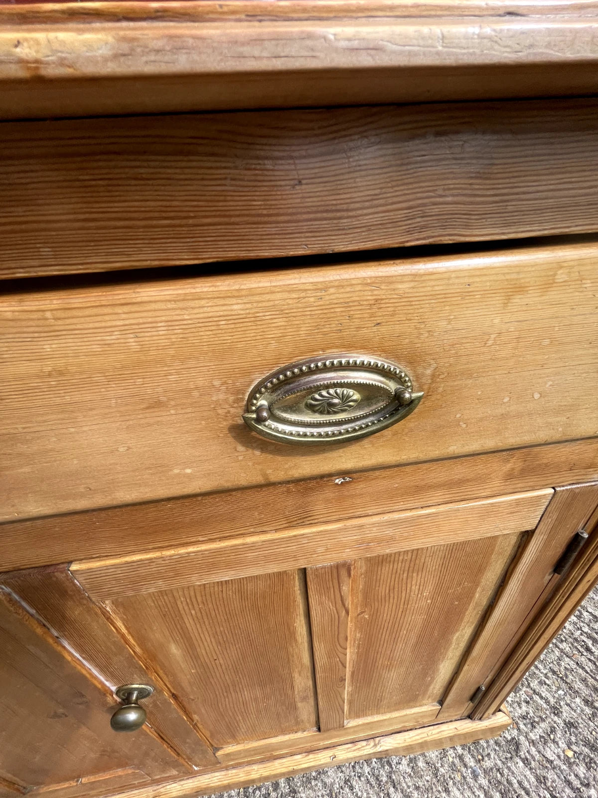 Close-up of a wooden cabinet with a metal handle