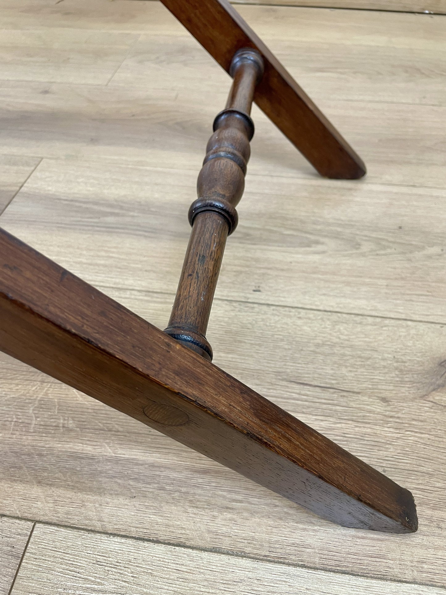 Close-up of a wooden chair leg on a wooden floor