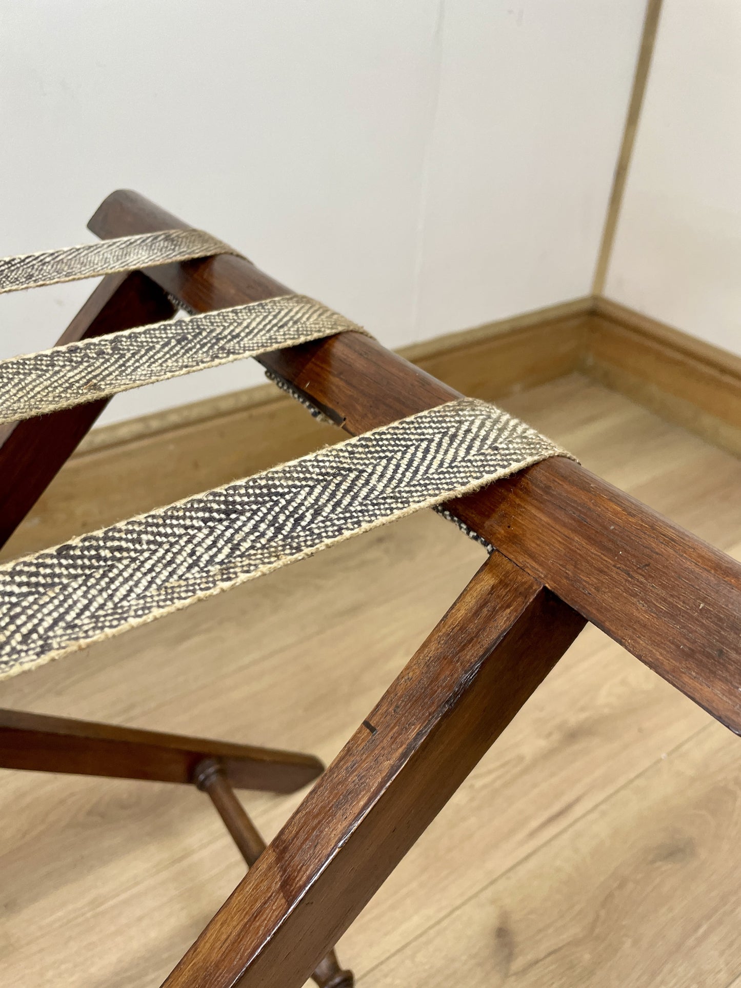 Wooden chair with woven seat on a wooden floor.