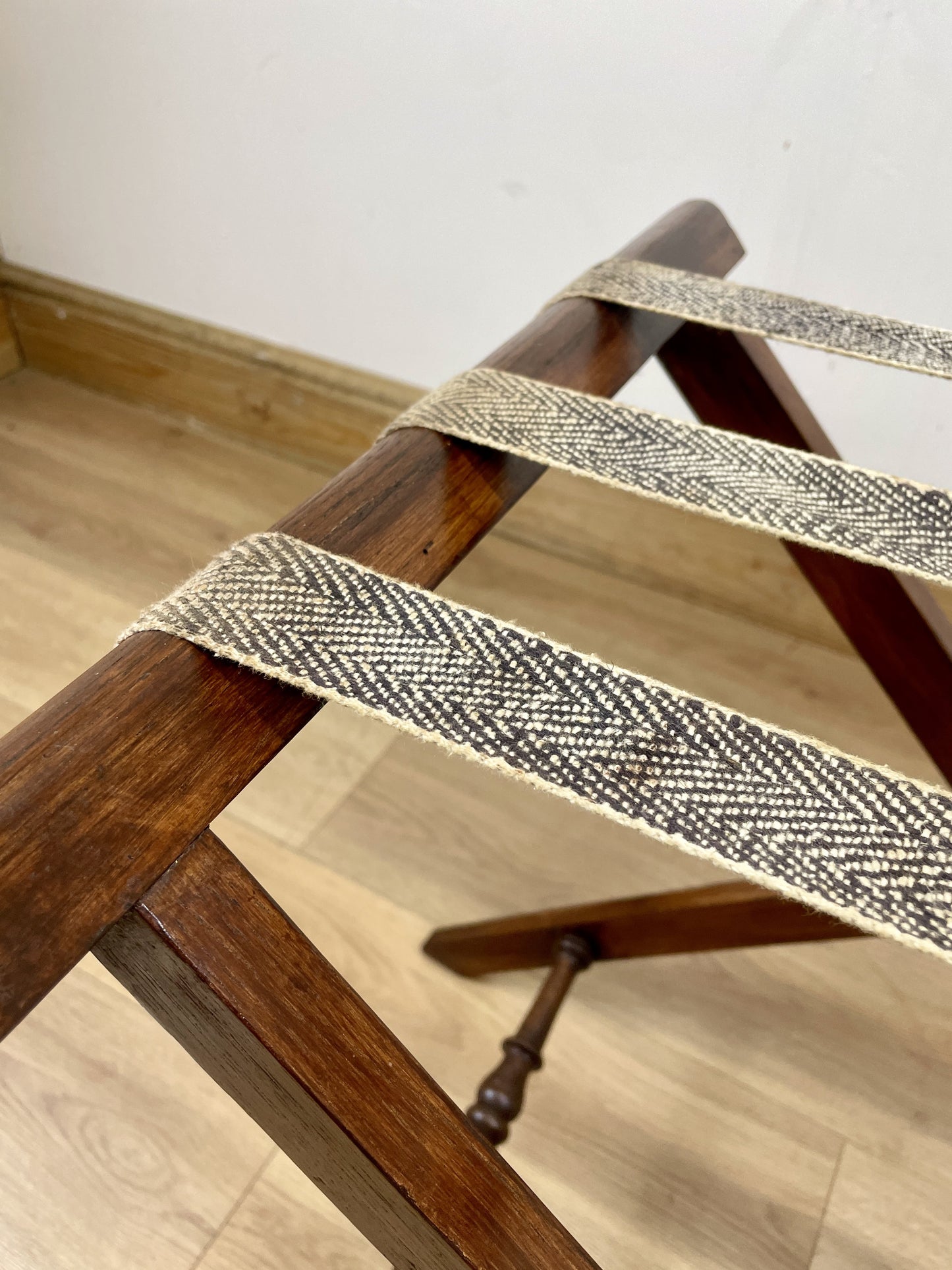 Wooden ladder with woven belt on a wooden floor