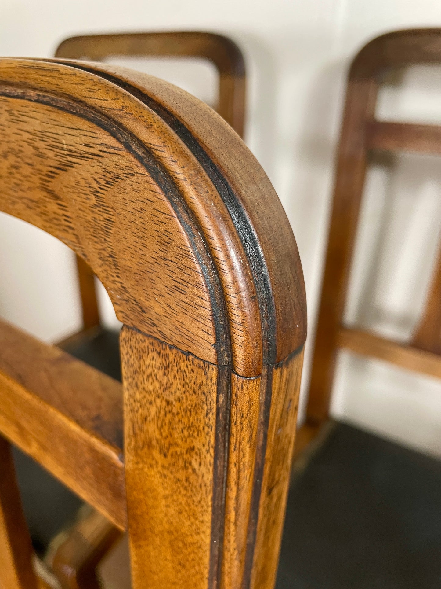 Close-up of a wooden chair with a blurred background