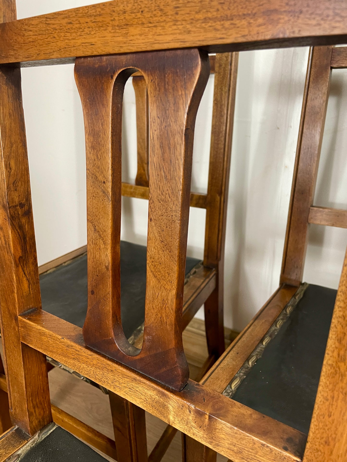 Close-up of a wooden chair with intricate design on a white background