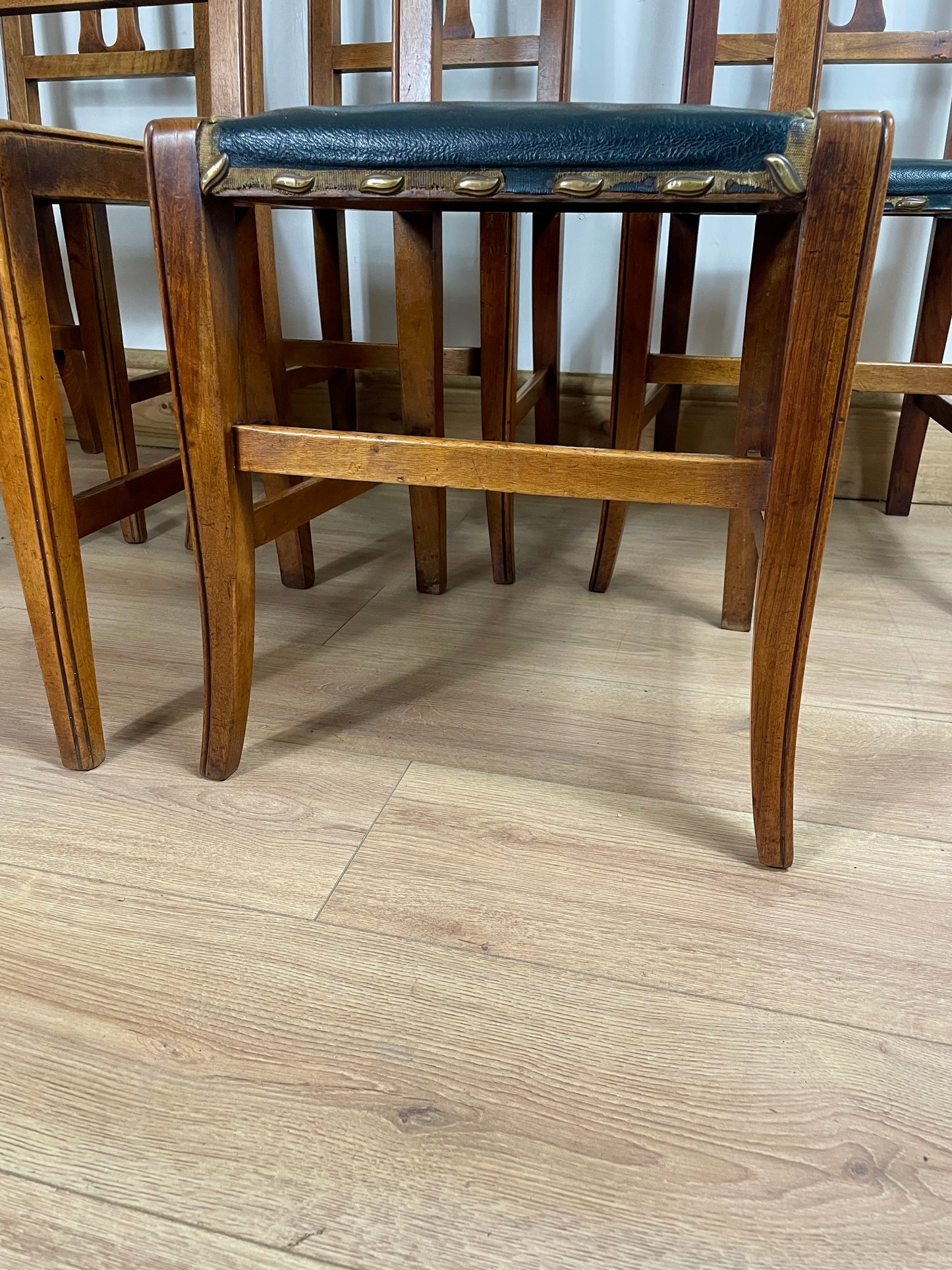 Wooden chair with a green cushion on a wooden floor