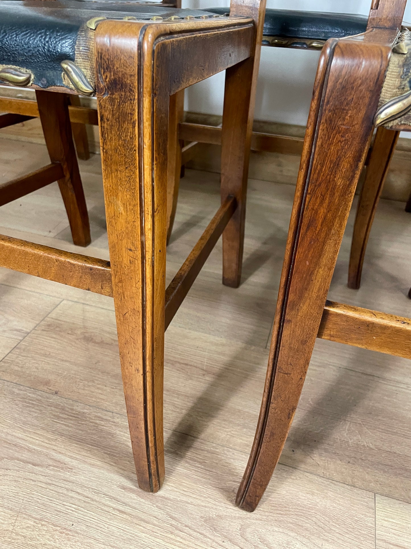 Close-up of wooden chair legs on a wooden floor