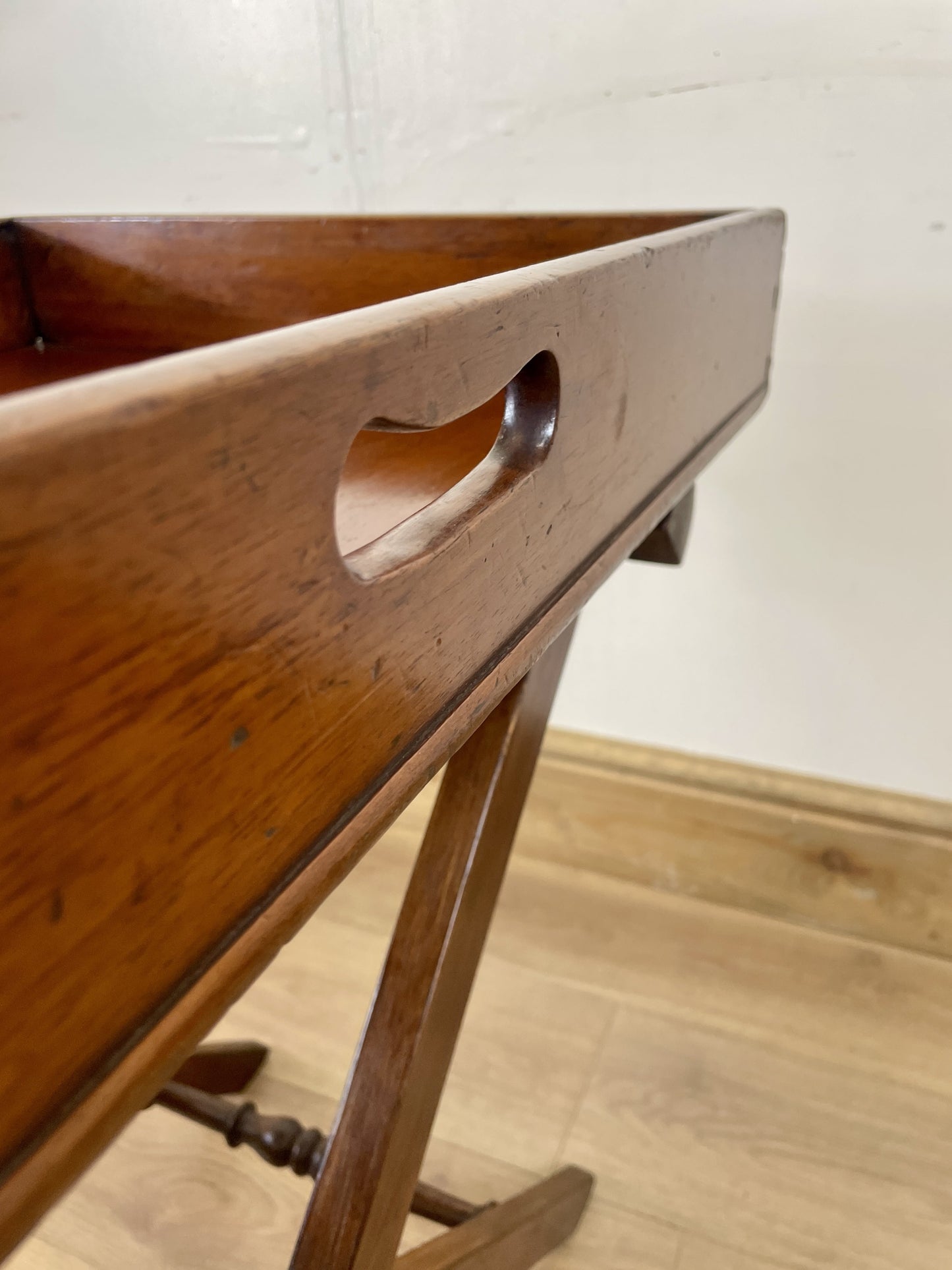 Wooden tray with handles on a wooden floor