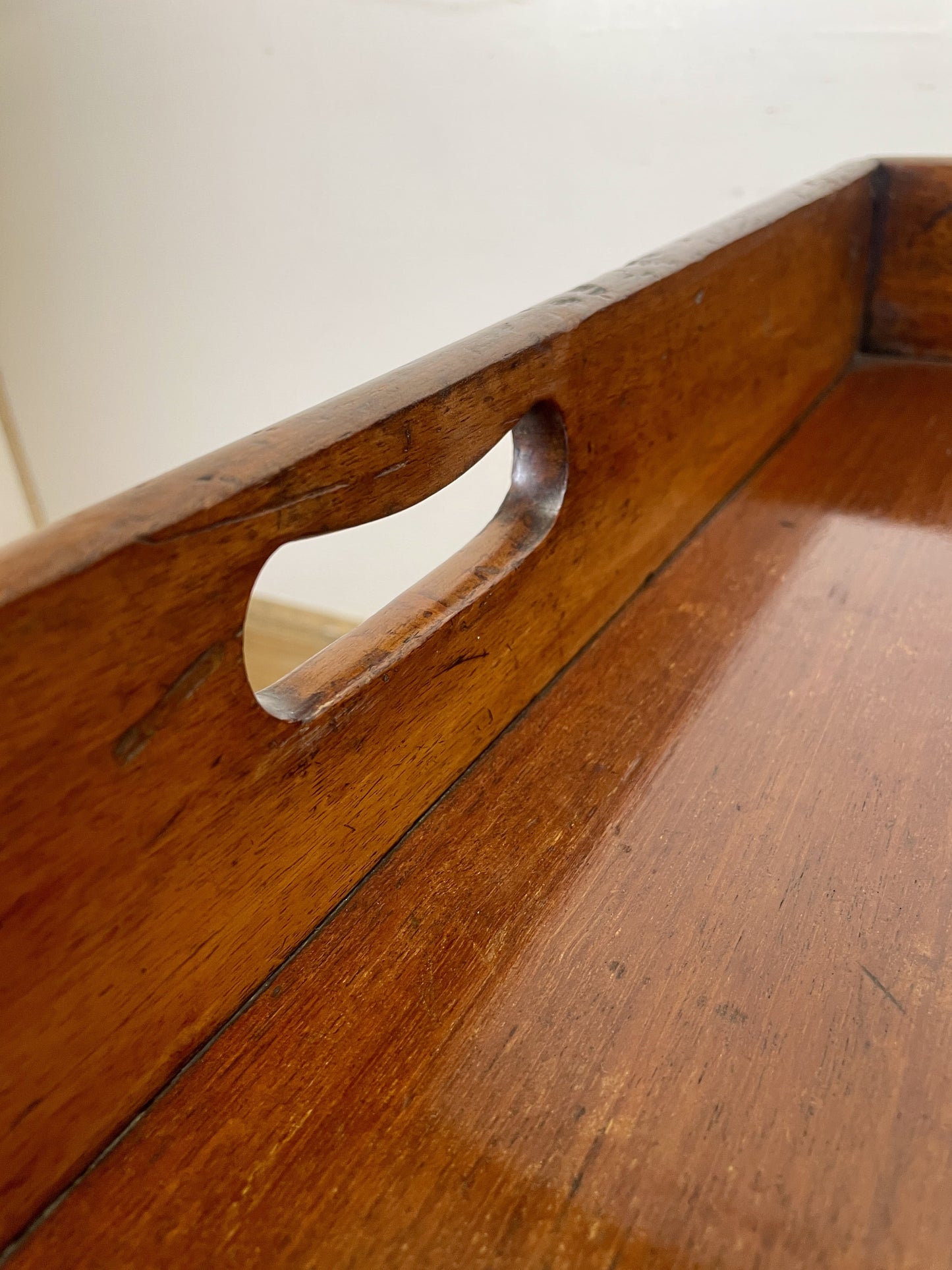 Close-up of a wooden tray with a handle on a white background