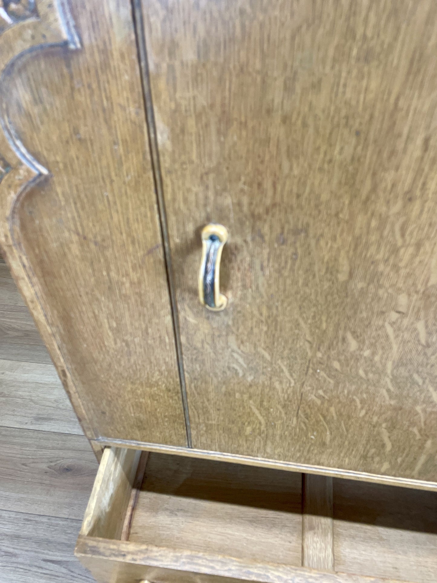 Wooden cabinet with a handle on a wooden floor