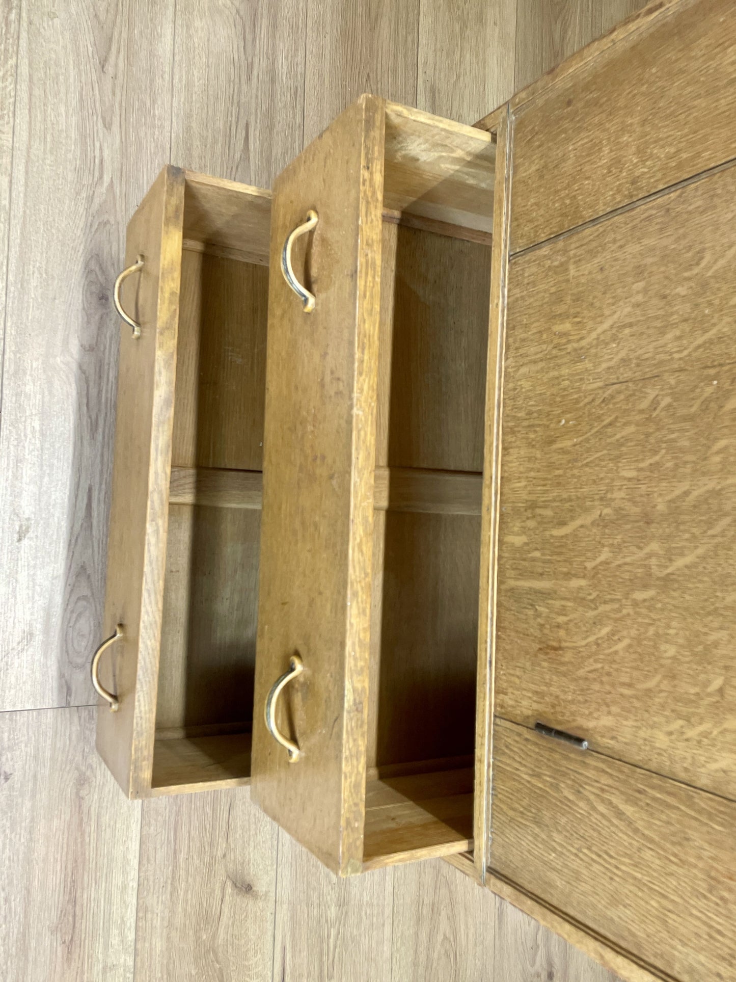 Wooden cabinet with open doors on a wooden floor