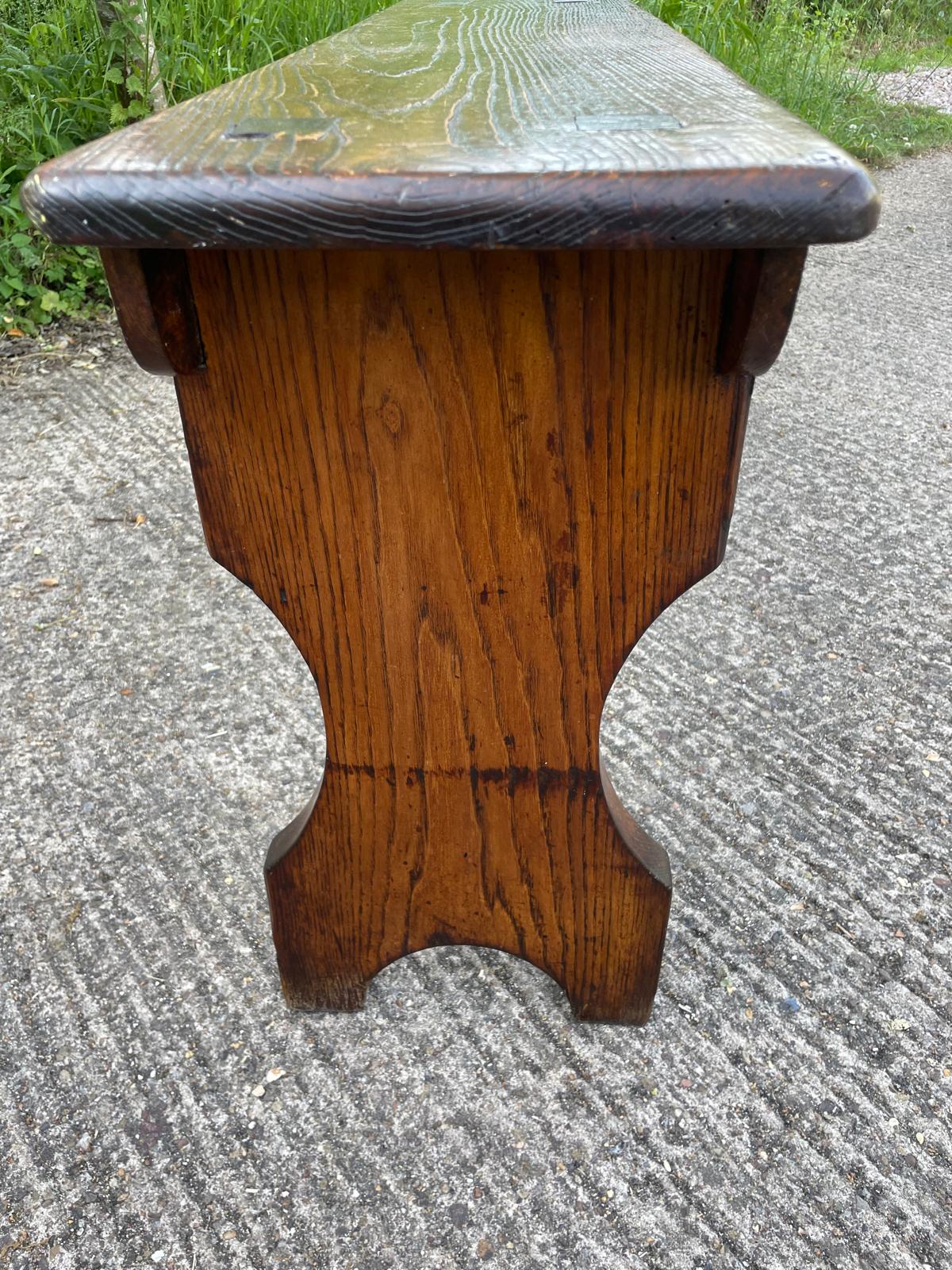 Wooden stool with a textured top on a concrete surface