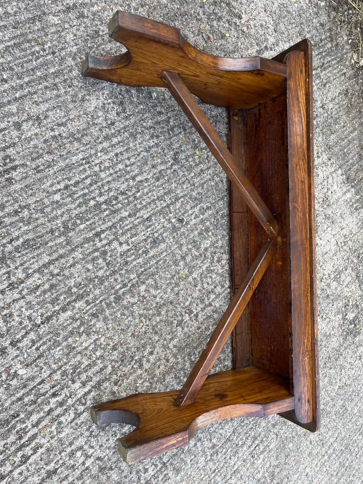 Wooden bracket on a textured gray surface