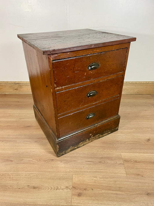 Antique pine wood chest of drawers with a dark brown finish, featuring three drawers with metal handles.