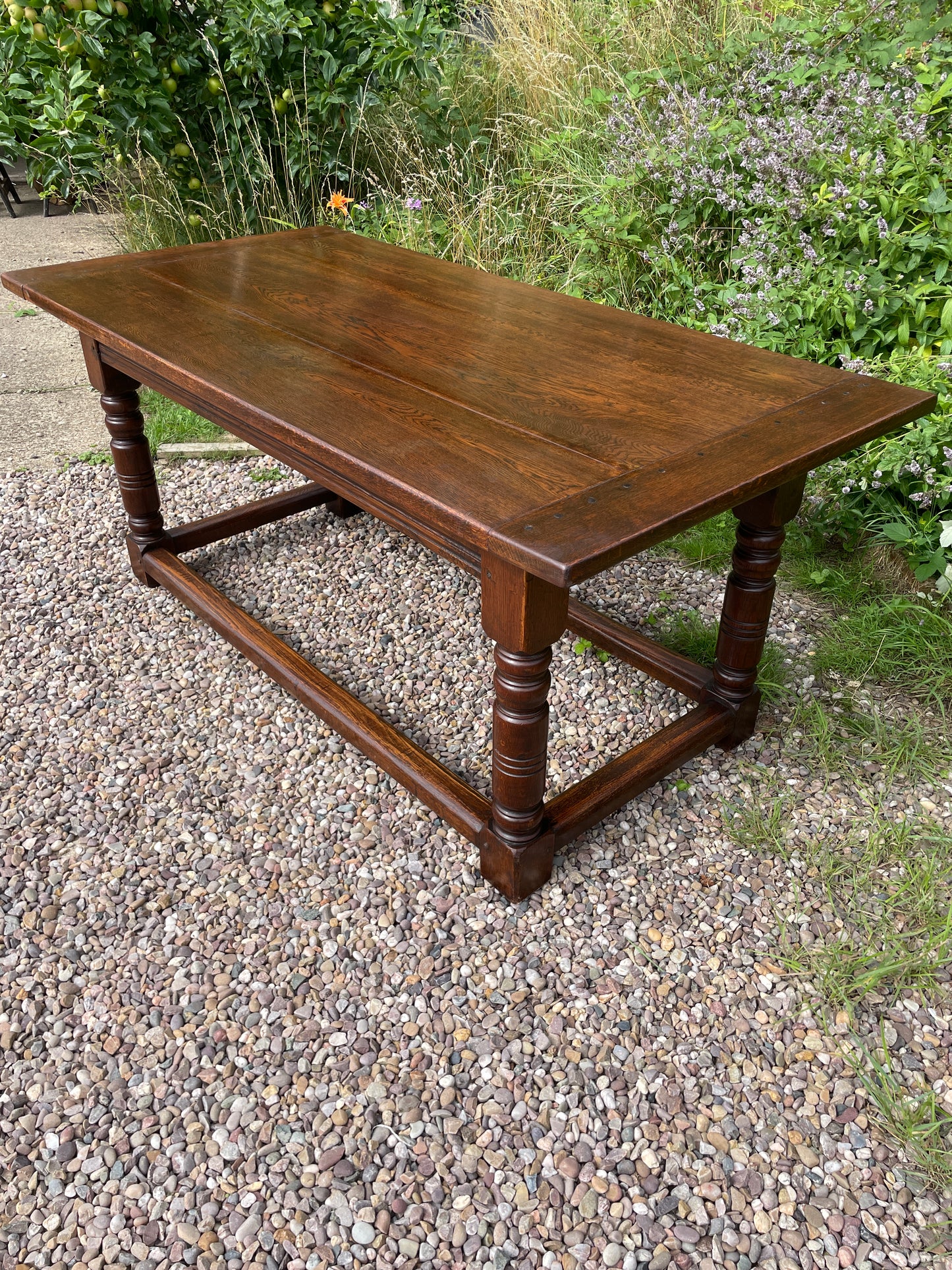 Wooden table on a gravel surface with grass in the background