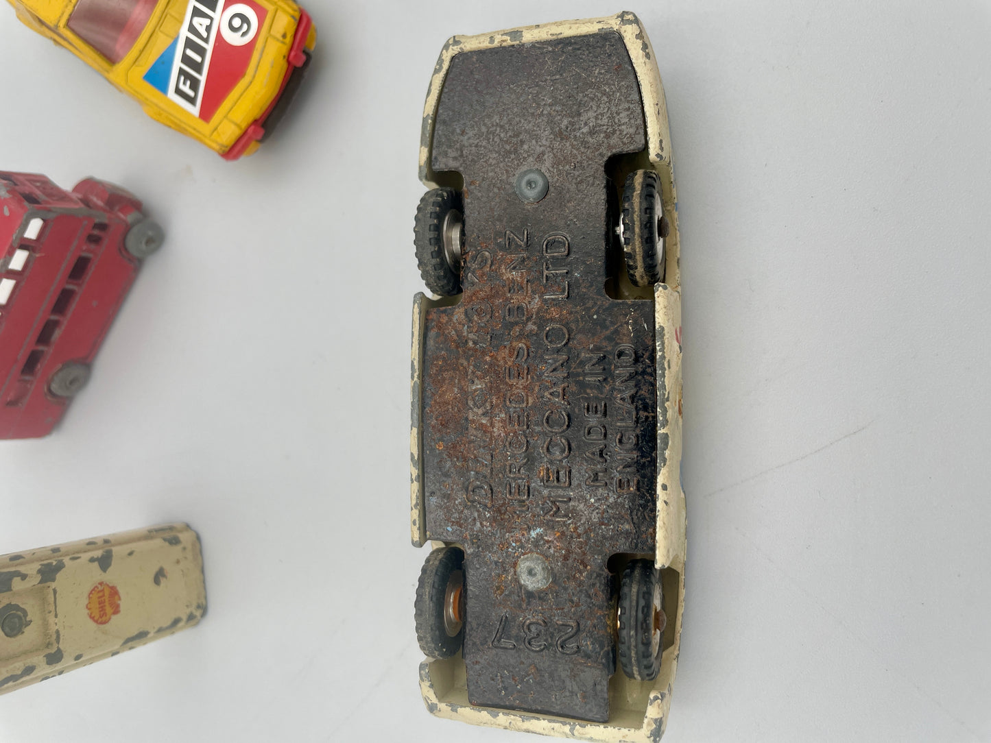Vintage toy car with branding on a white background
