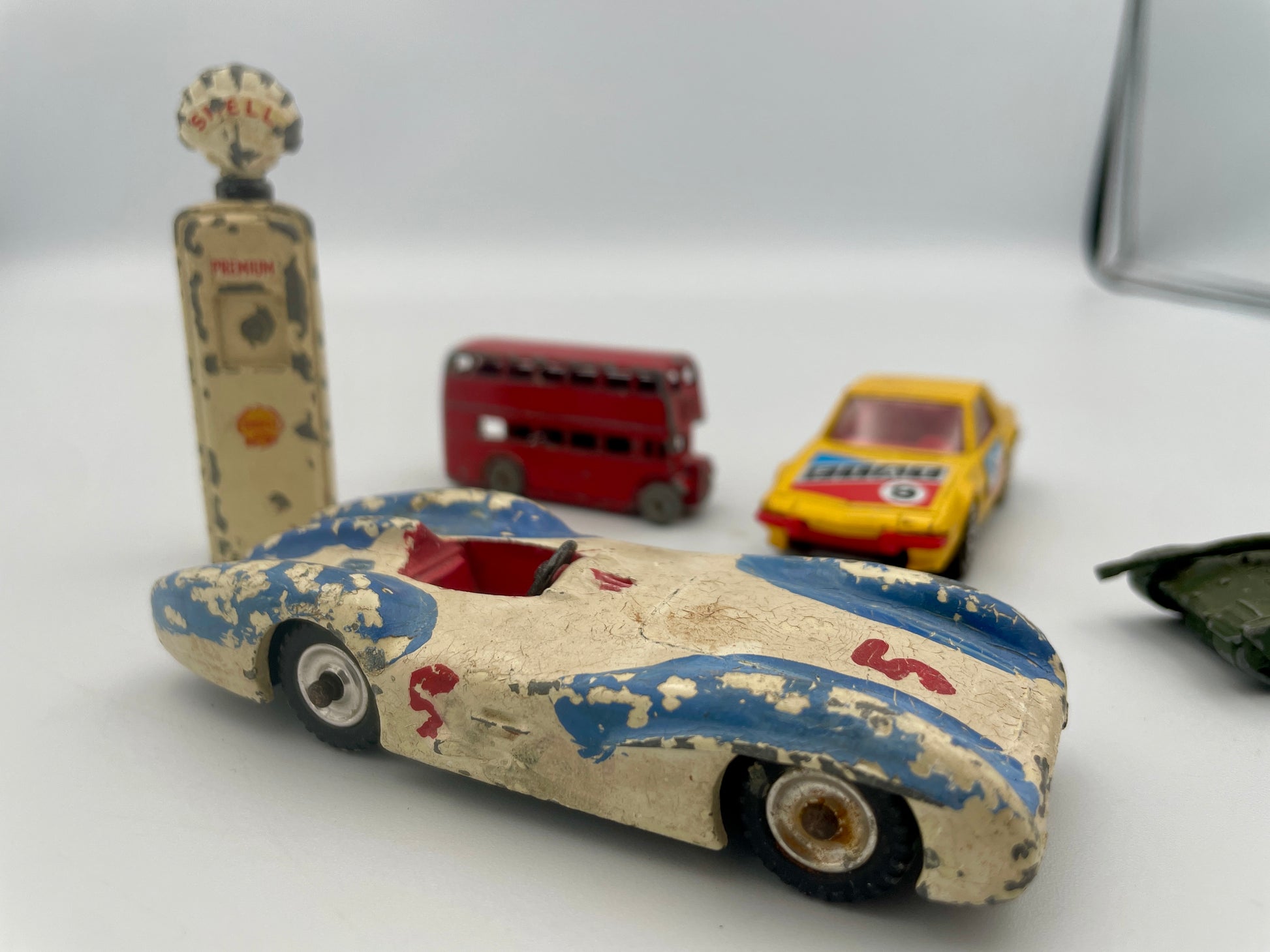 Vintage toy cars on a white surface