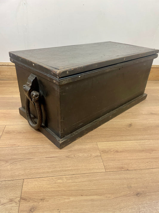 Vintage wooden box with metal handle on a wooden floor