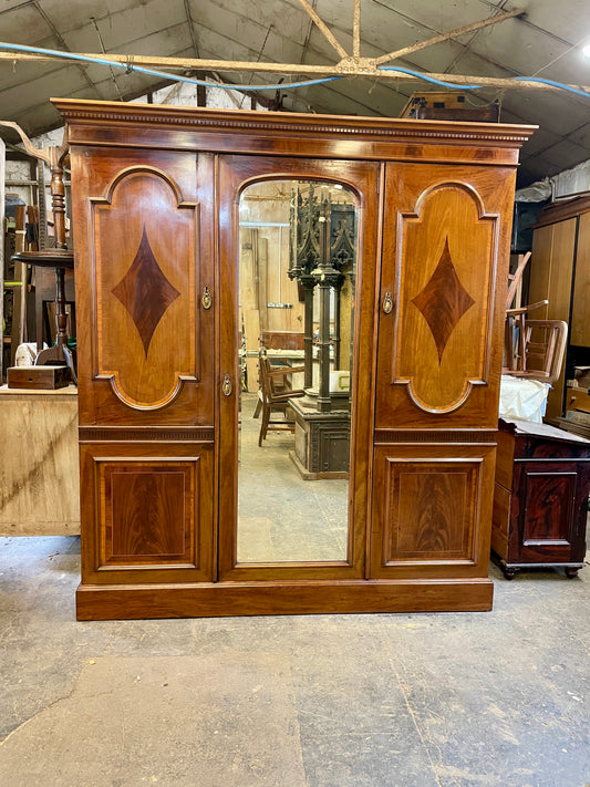 Wooden wardrobe with mirror in a warehouse setting