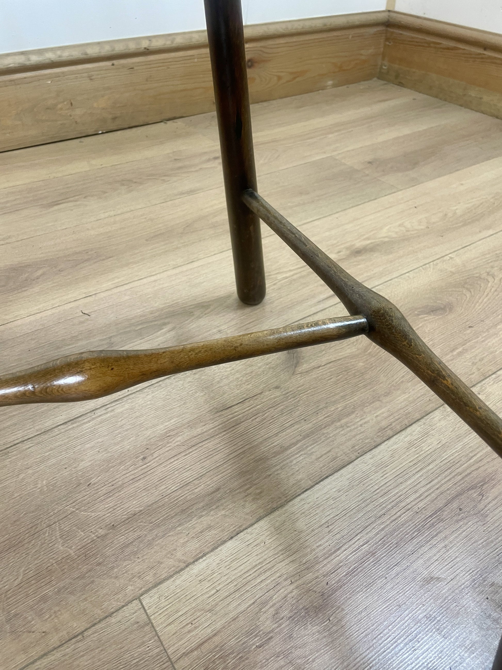 Brown wooden chair leg on a wooden floor