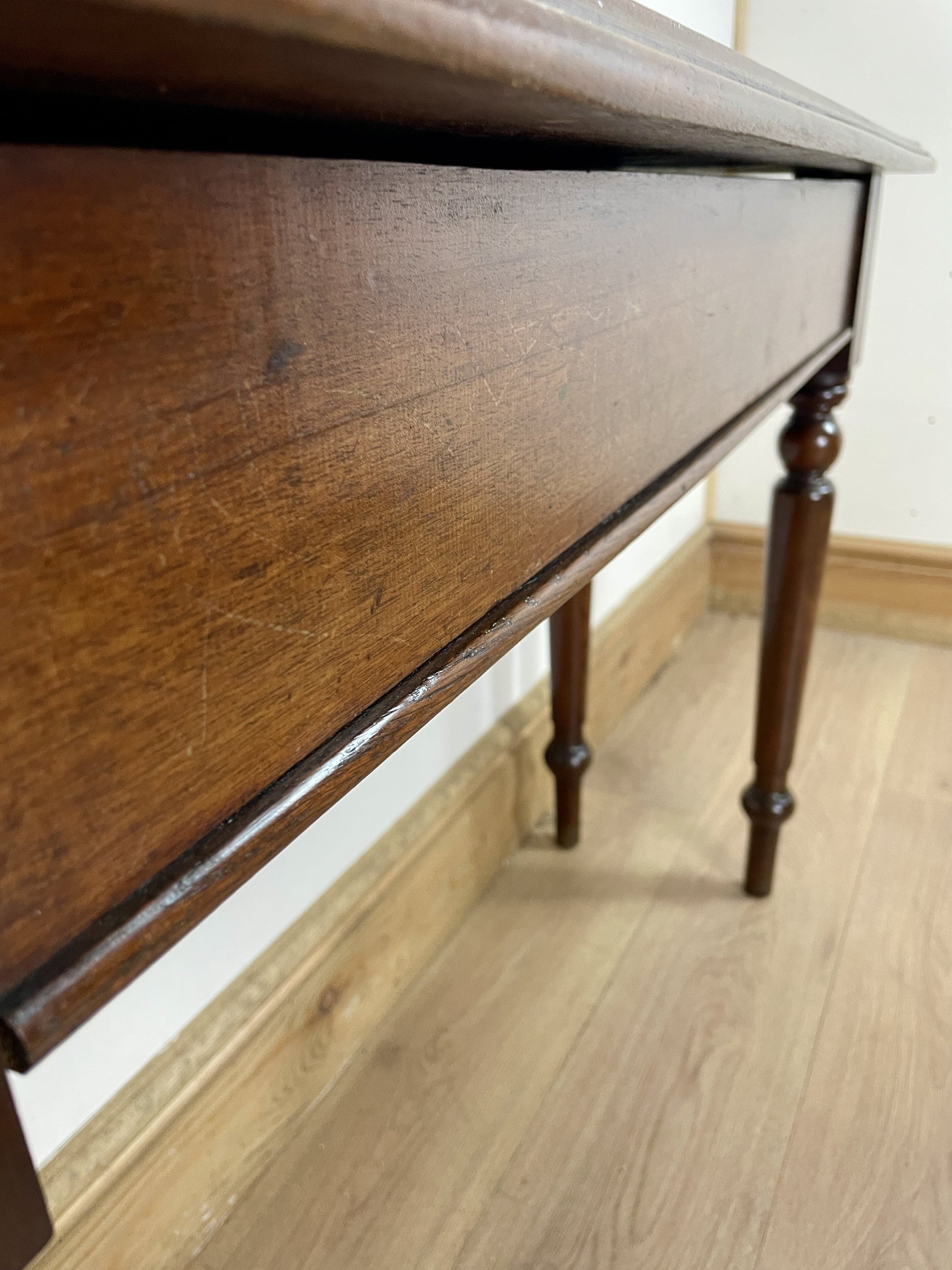 Close-up of a wooden drawer with a light background