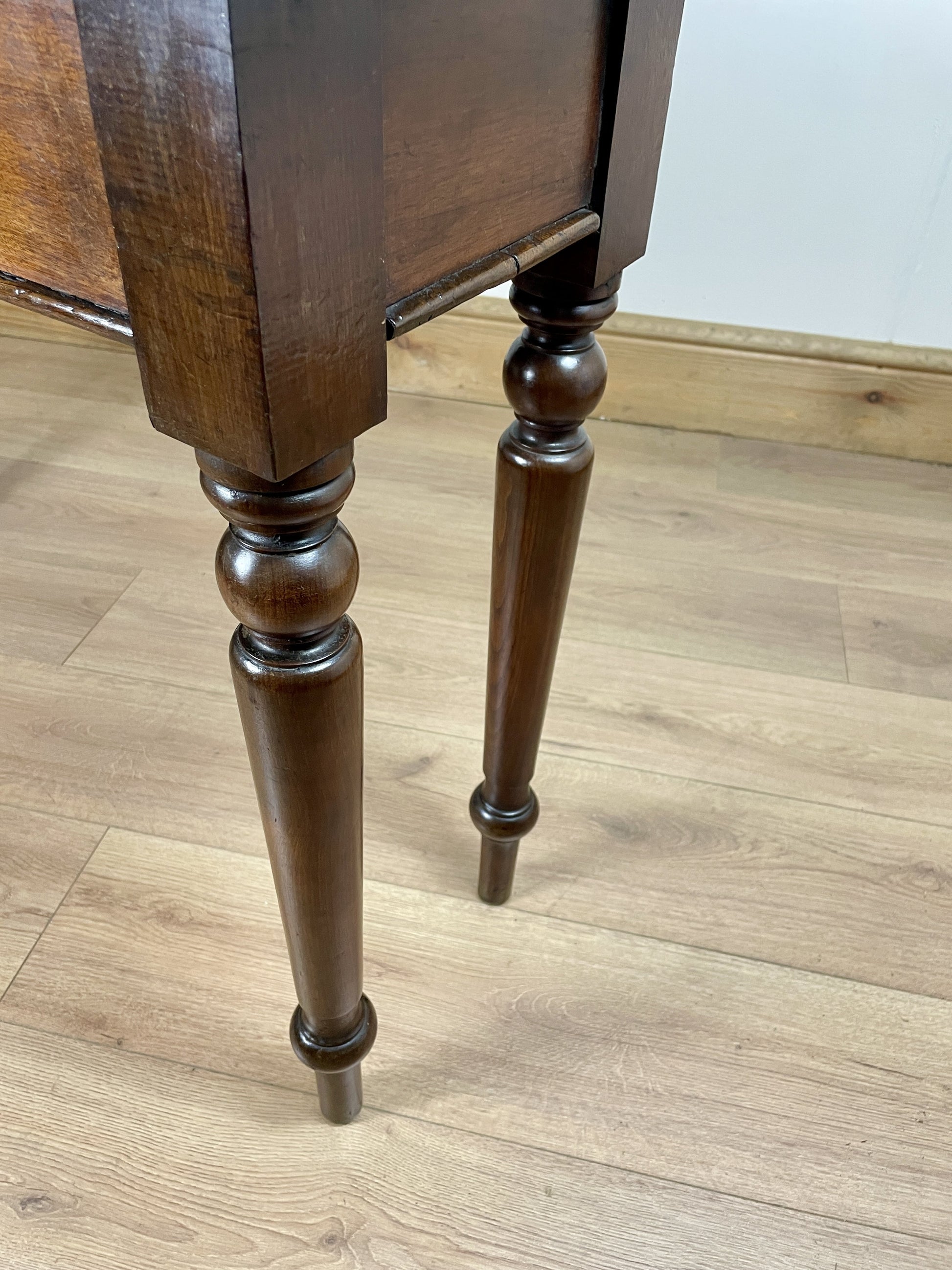 Wooden table with turned legs on a wooden floor