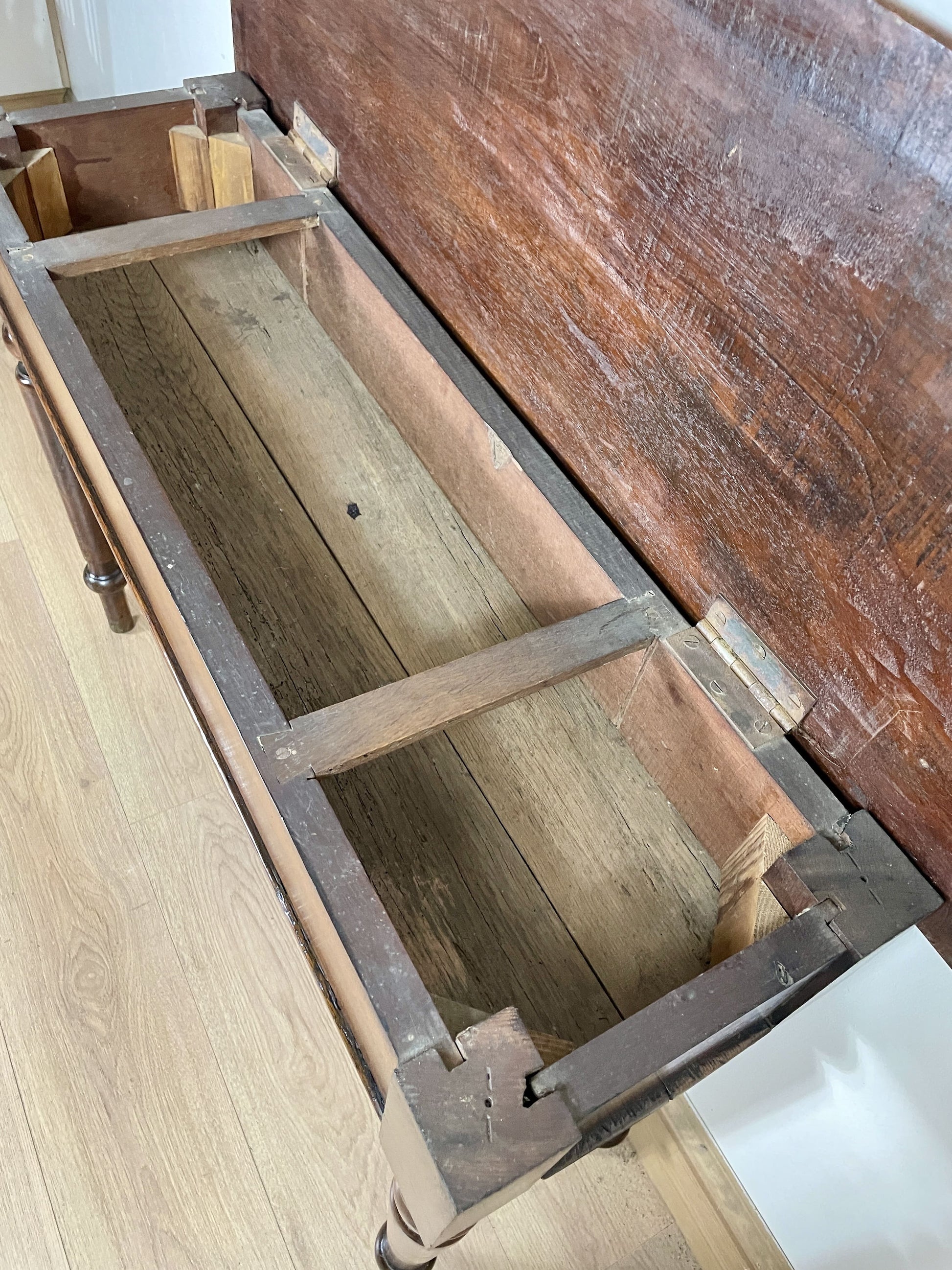 Wooden box with a lid on a wooden floor