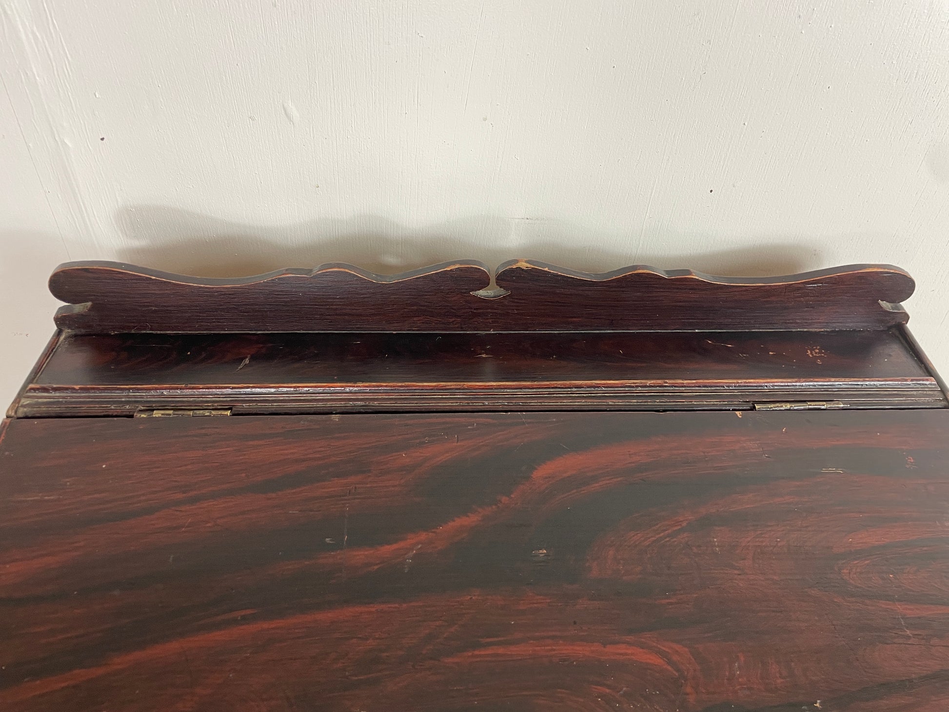 Wooden shelf with decorative backrest on a white background