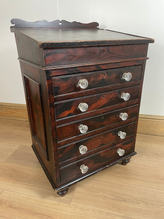 Wooden cabinet with glass knobs on a wooden floor