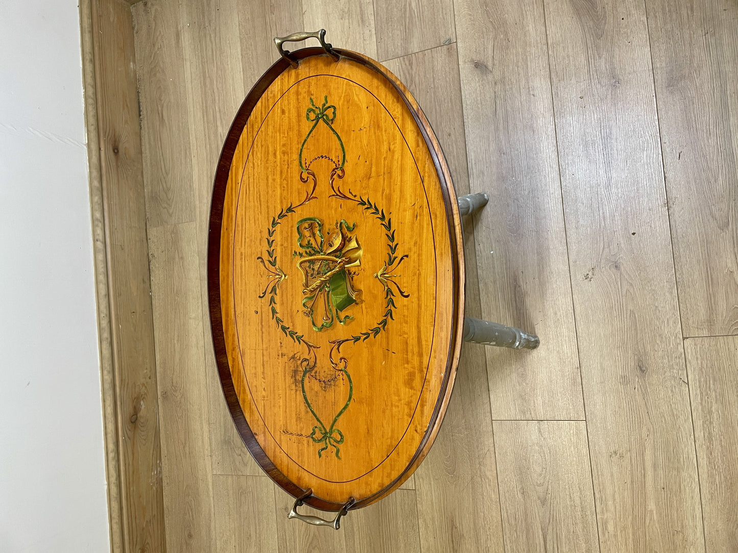 Decorative wooden barrel with a design on a wooden floor