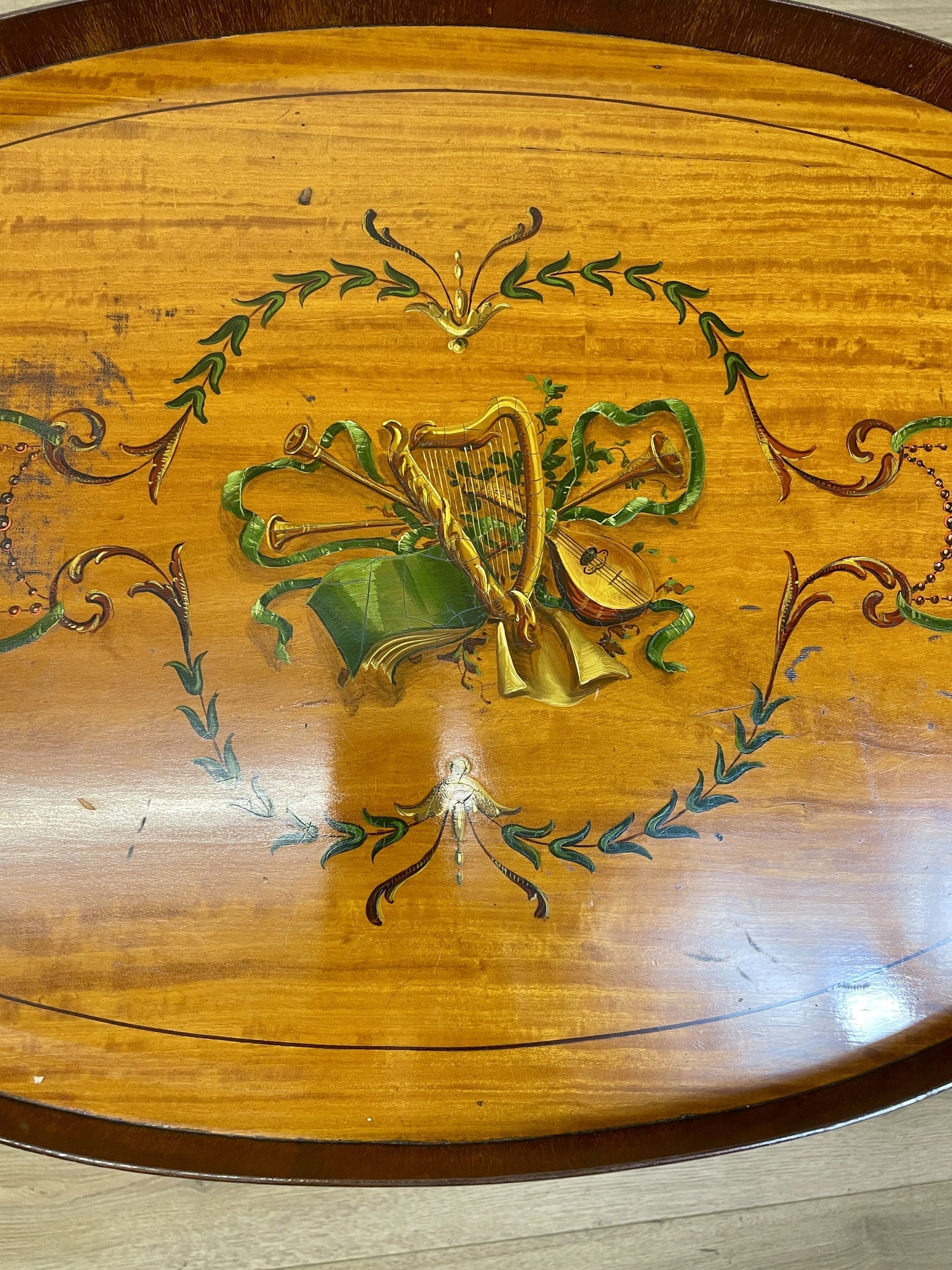Wooden surface with decorative harp design