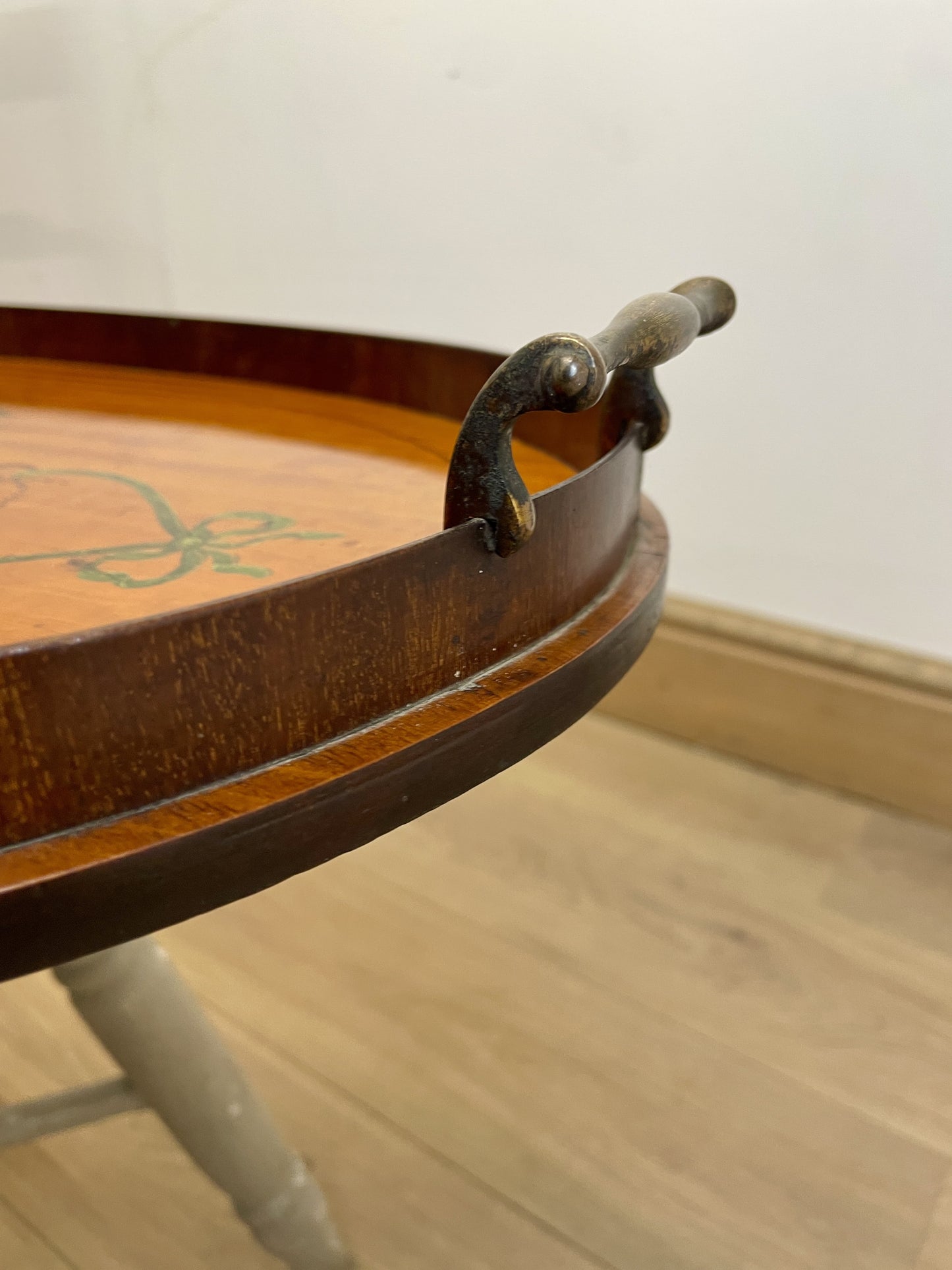 Wooden tray with a handle on a wooden floor