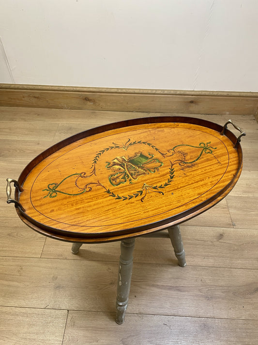 Wooden tray table with decorative design on a wooden floor