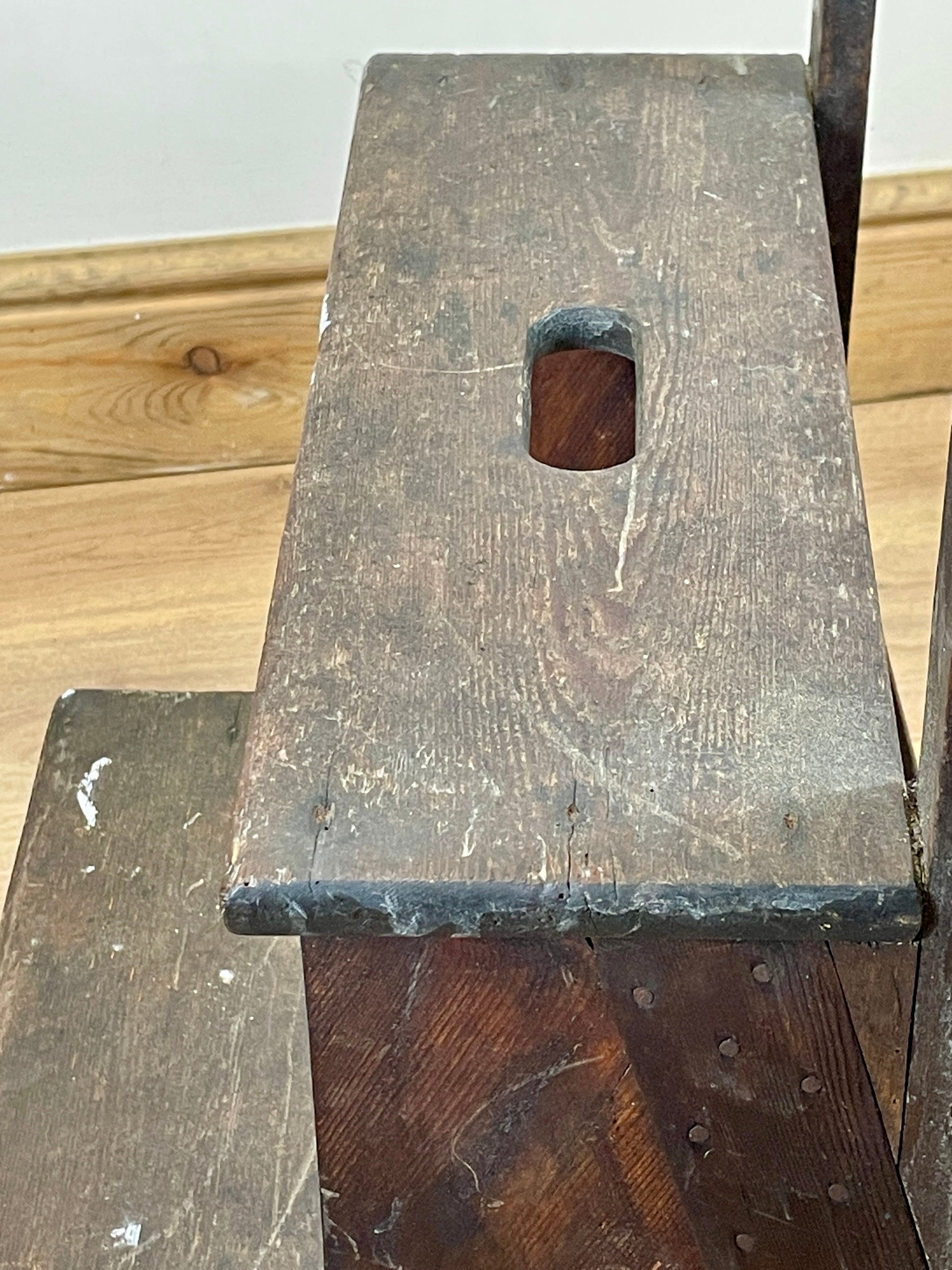 Wooden block with a central hole on a wooden surface