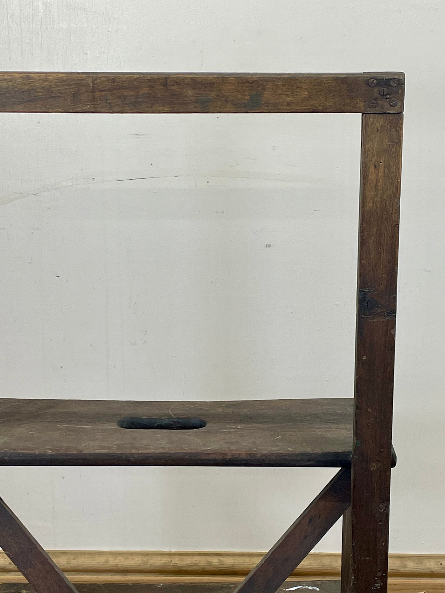 Wooden ladder against a white wall