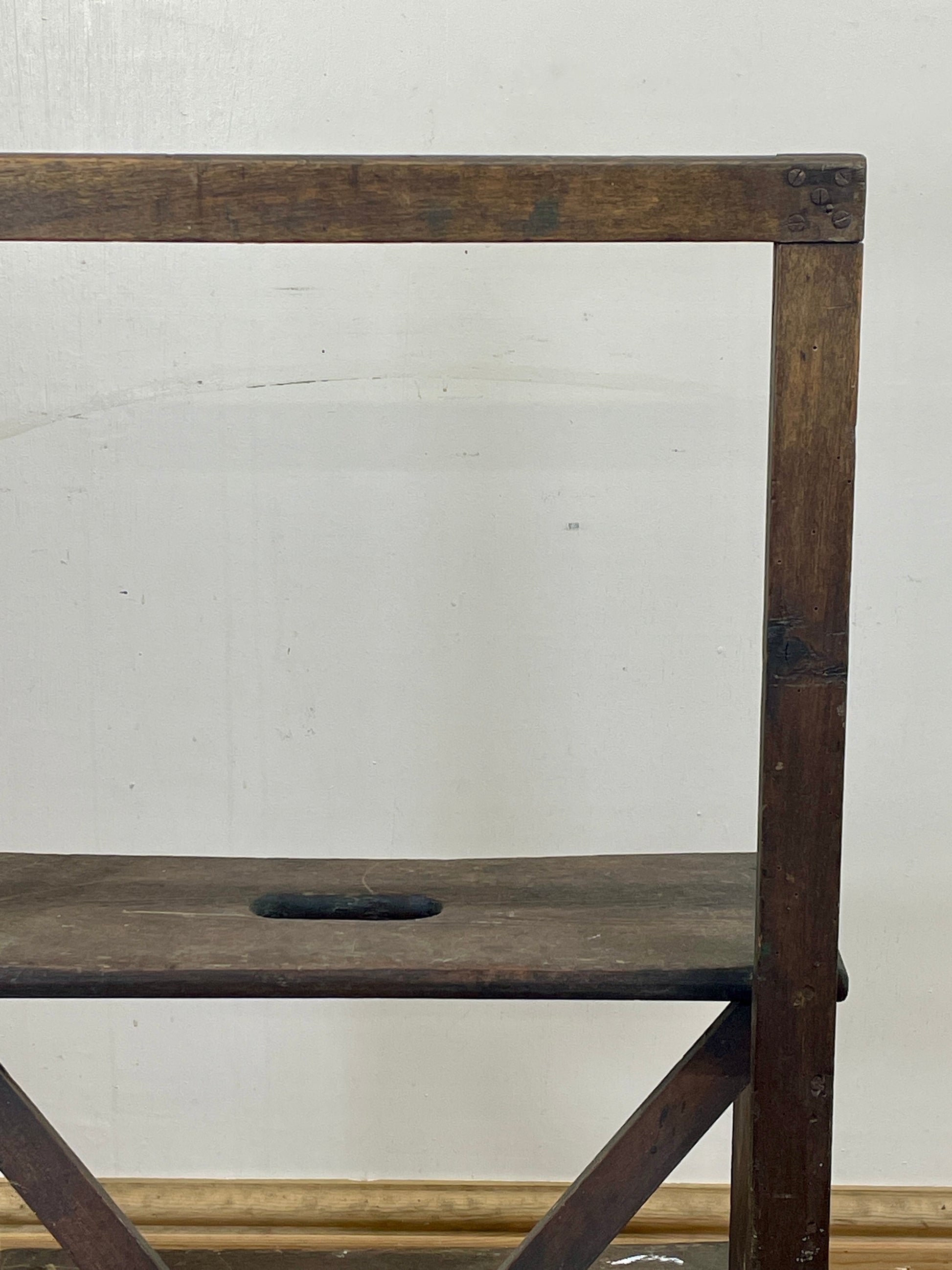 Wooden ladder against a white wall