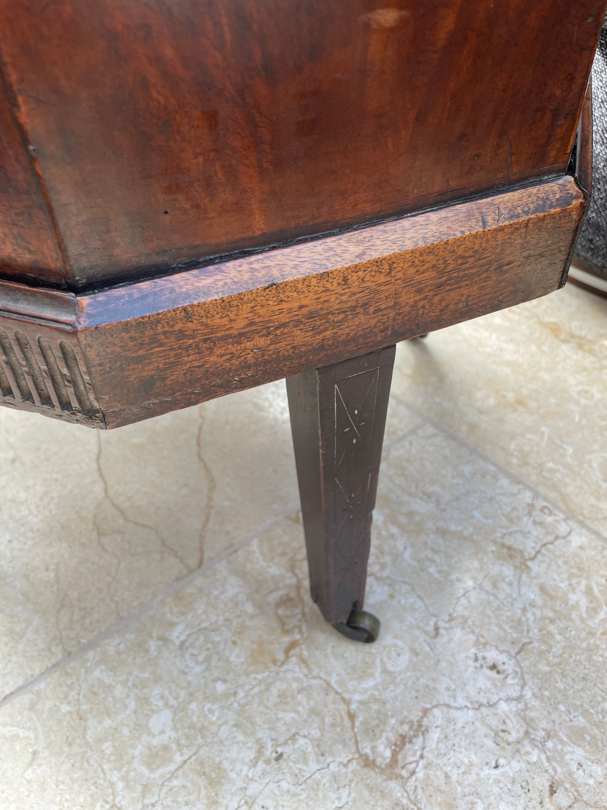Wooden stool with metal legs on a marble floor