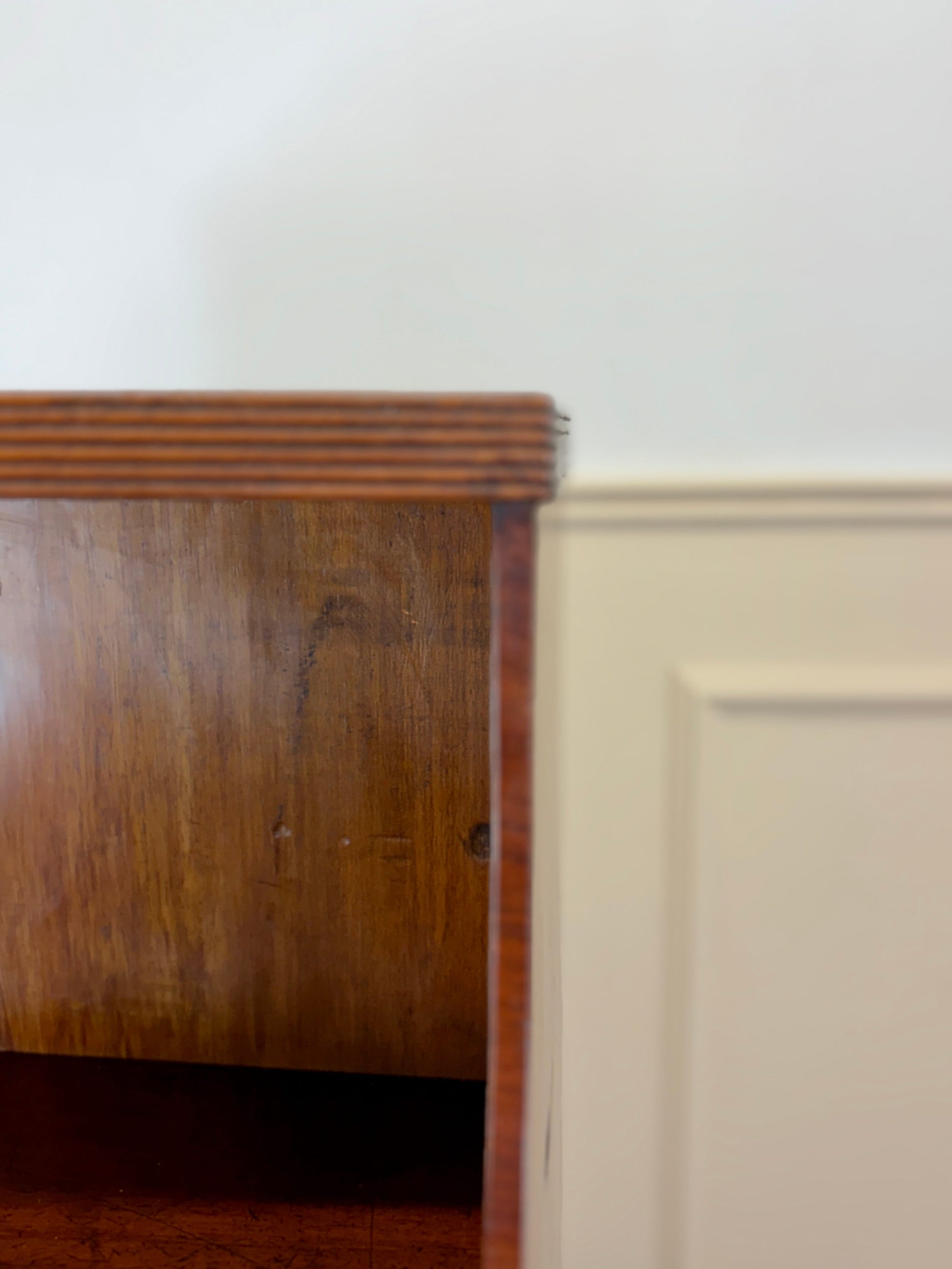 Front view of an antique Georgian mahogany small waterfall bookcase with two deep drawers