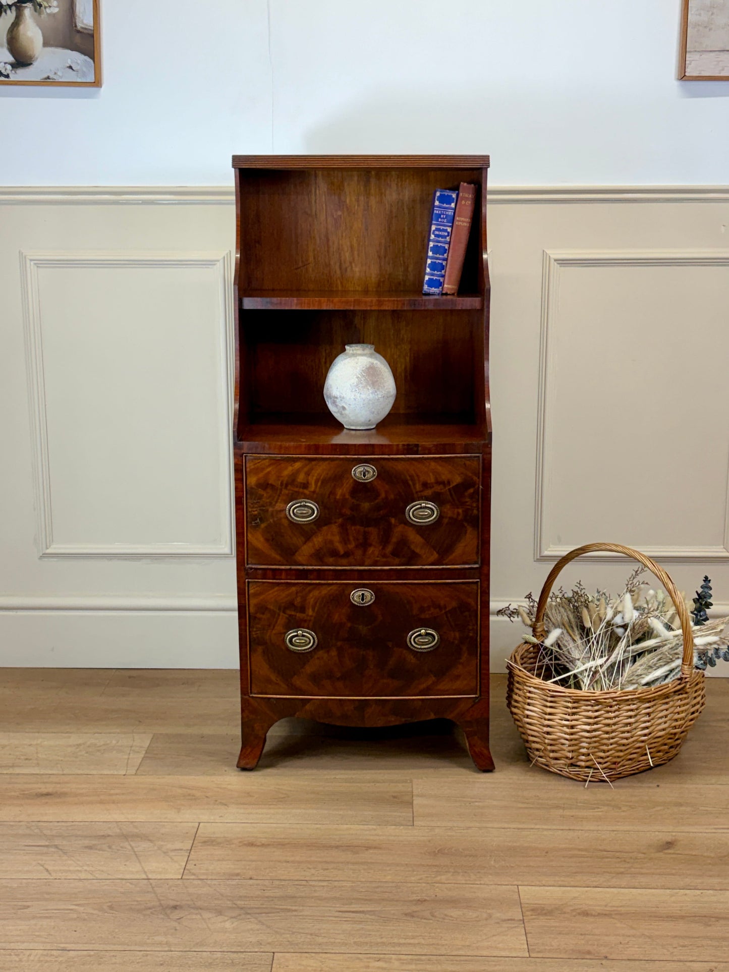 Front view of an antique Georgian mahogany small waterfall bookcase with two deep drawers