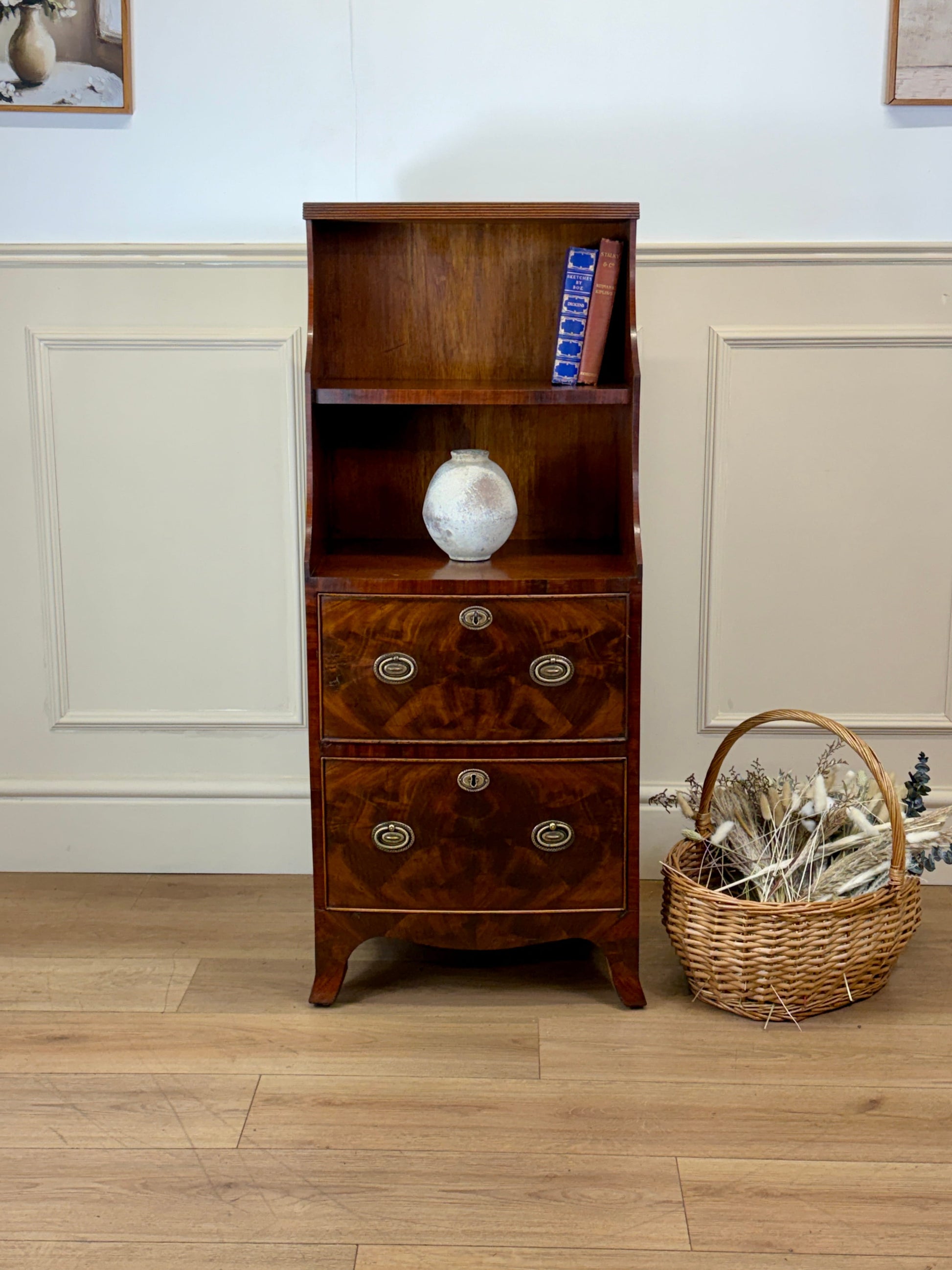 Front view of an antique Georgian mahogany small waterfall bookcase with two deep drawers