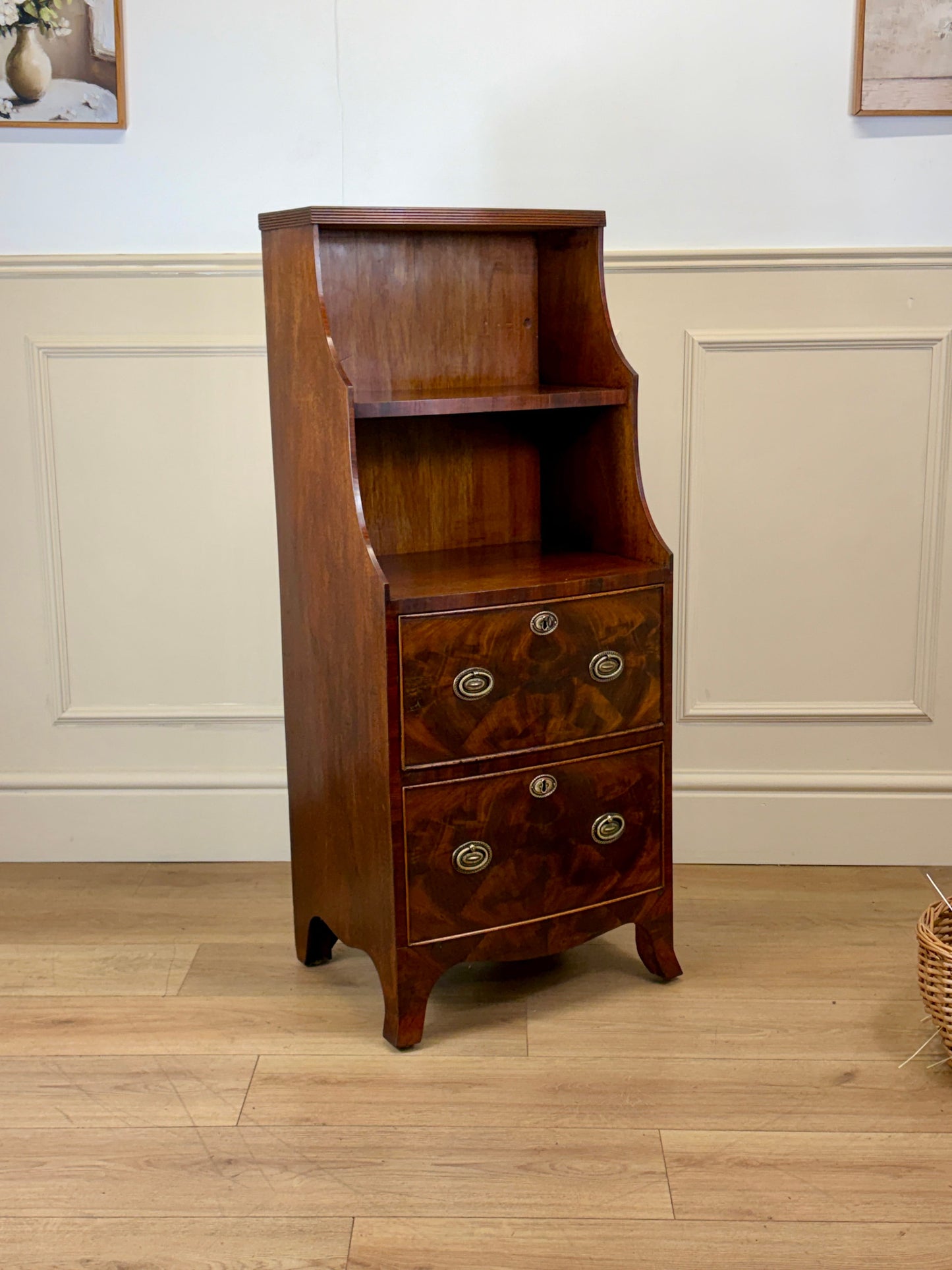 Front view of an antique Georgian mahogany small waterfall bookcase with two deep drawers