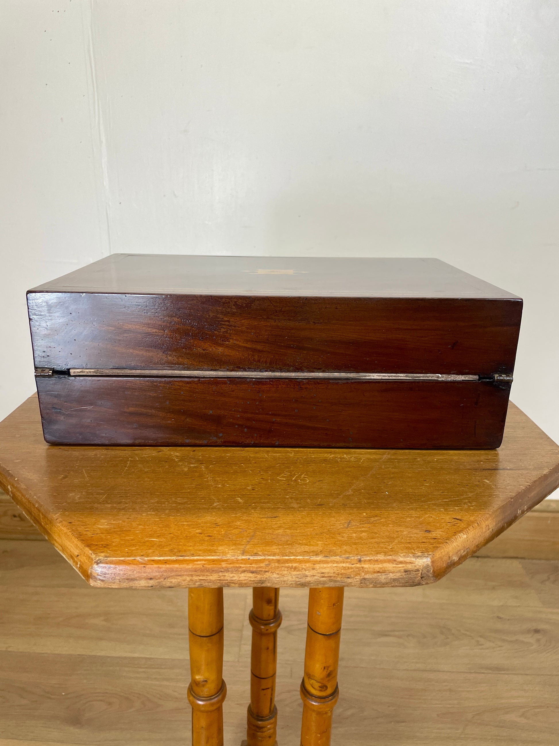 Wooden box on a wooden table with a plain background