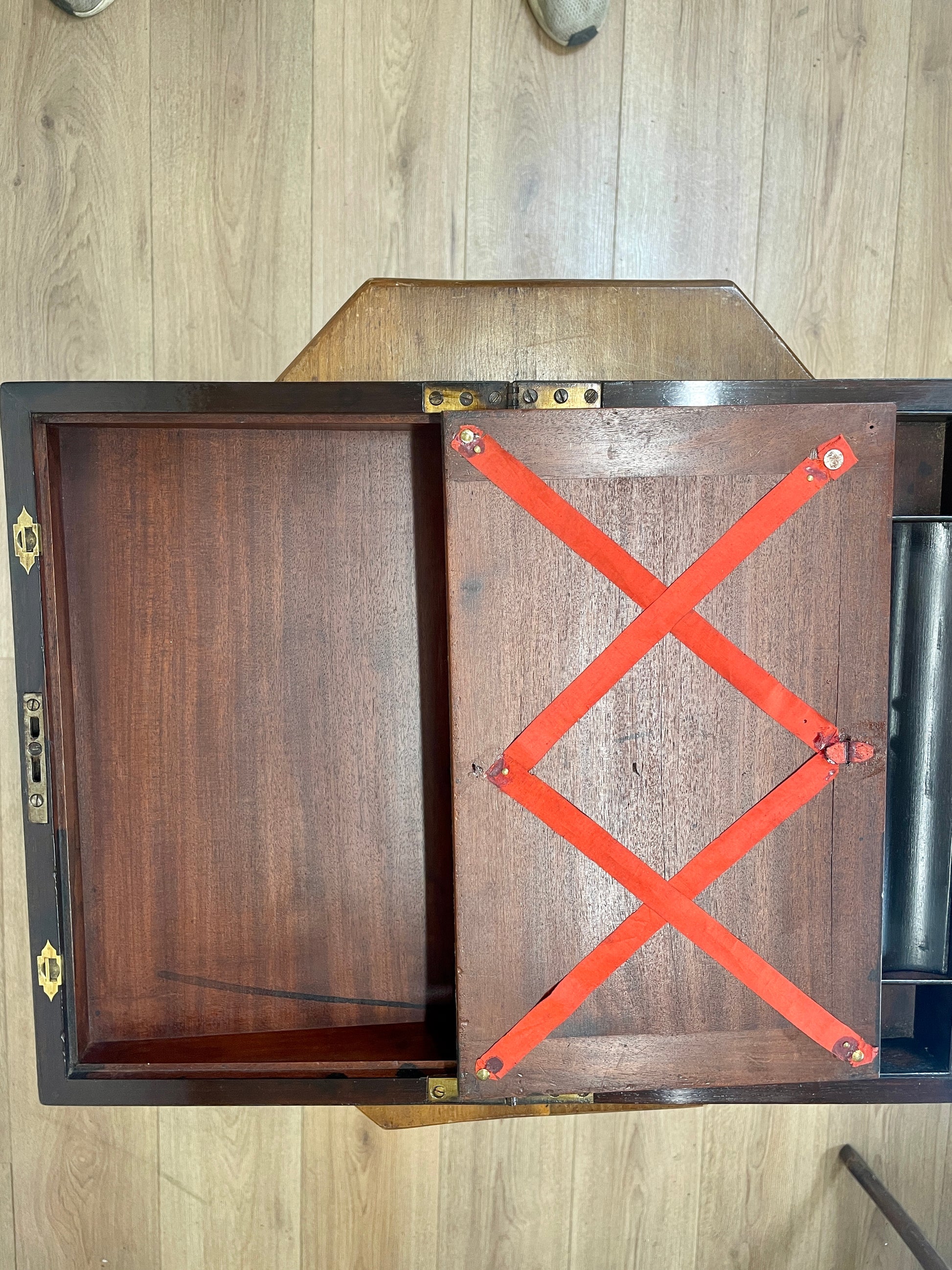 Wooden box with a red cross on a wooden surface
