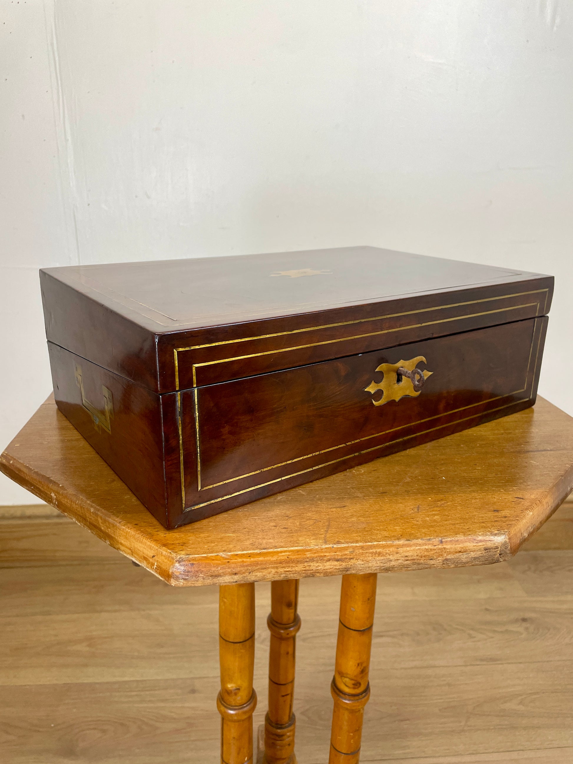 Wooden jewelry box on a wooden table with a white background