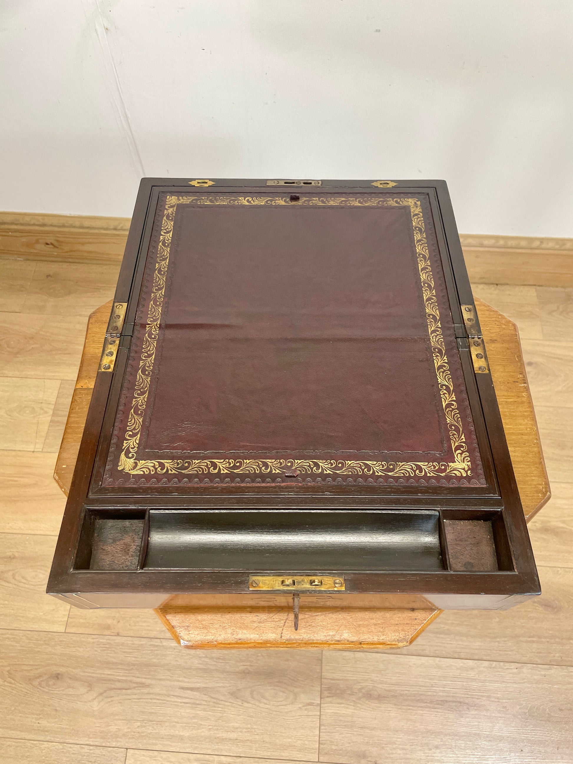 Wooden desk with leather surface on a wooden floor
