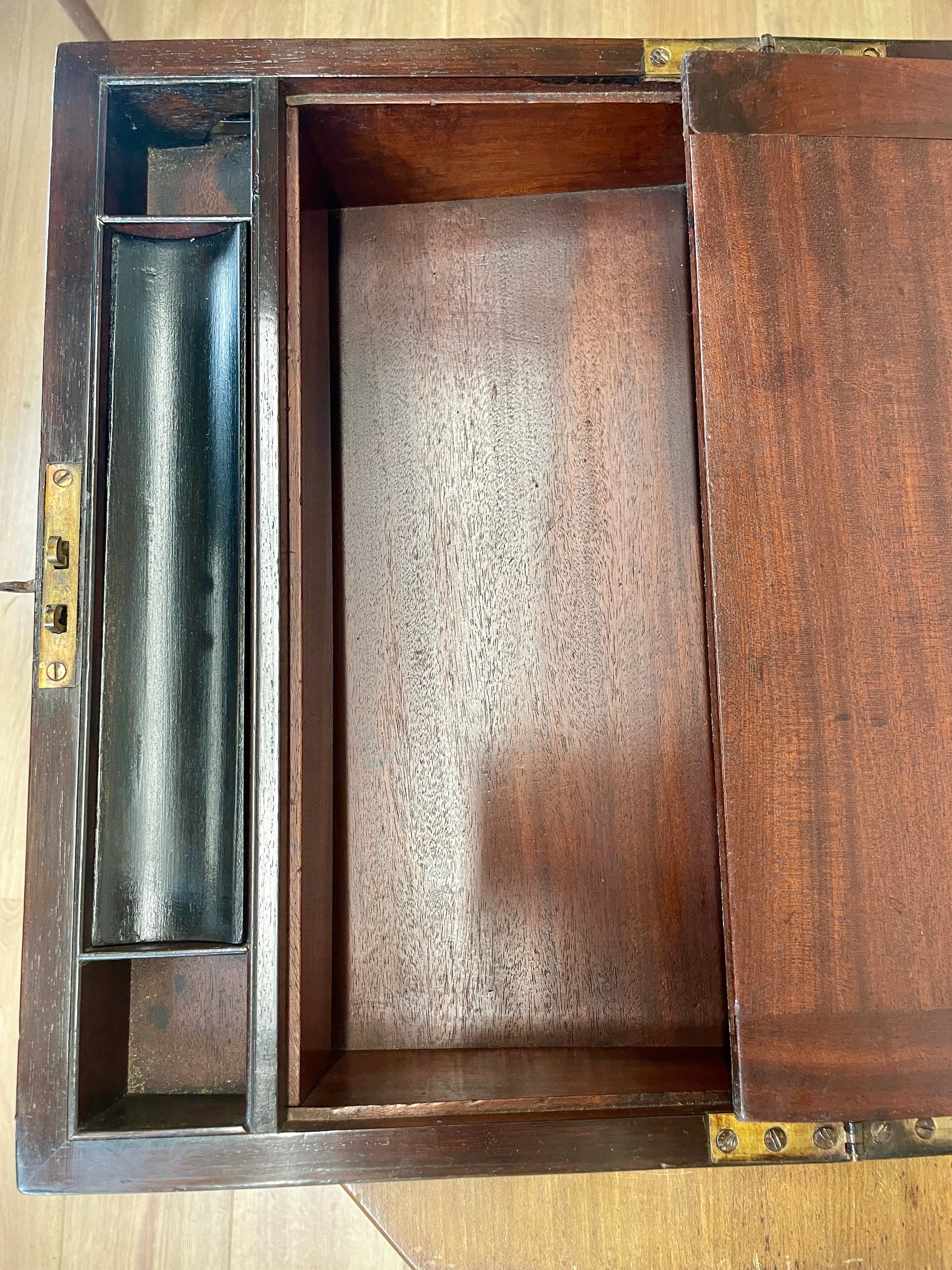 Wooden box with a lid open, revealing an interior compartment.