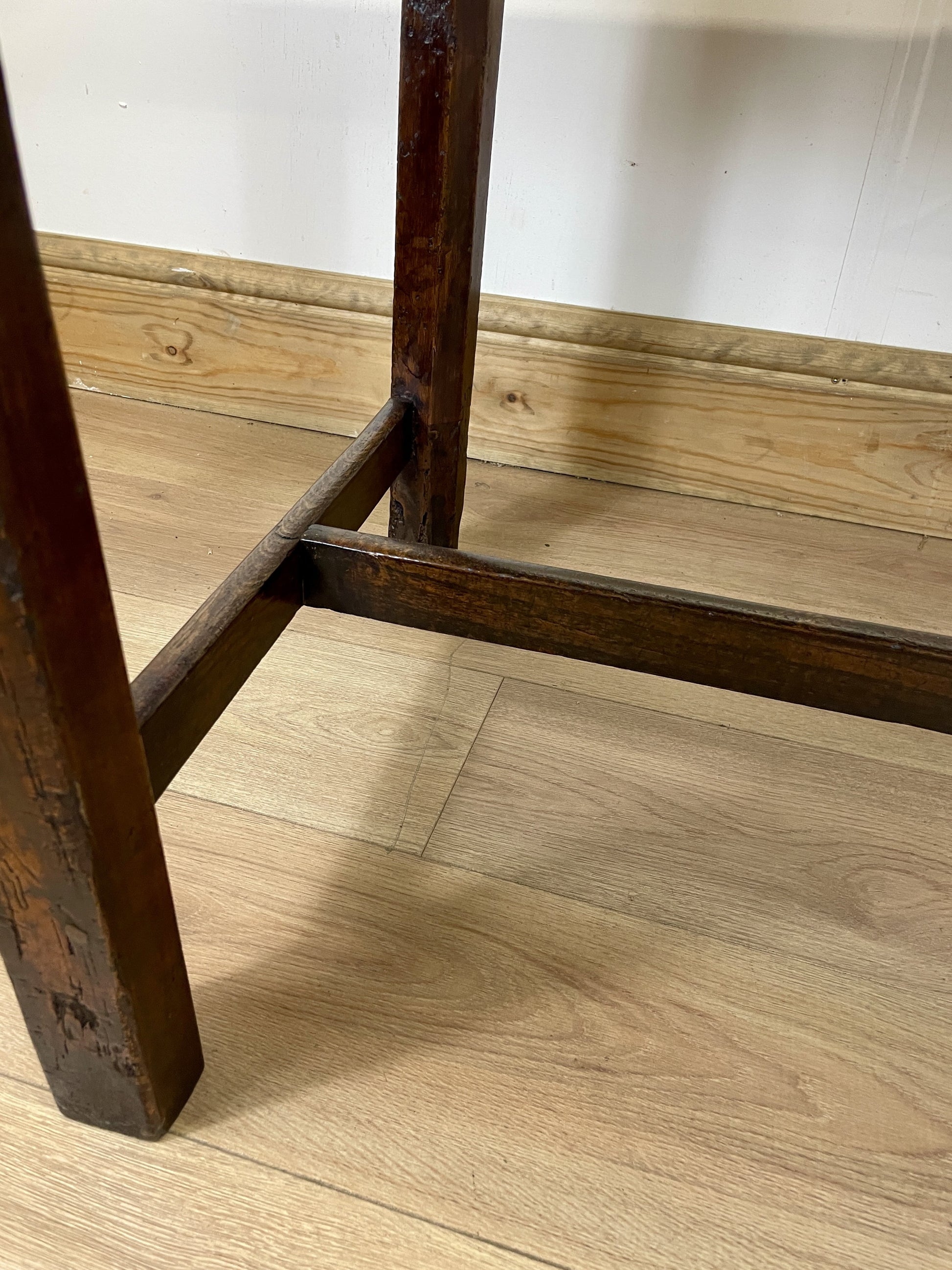 Wooden floor with a chair leg and base visible