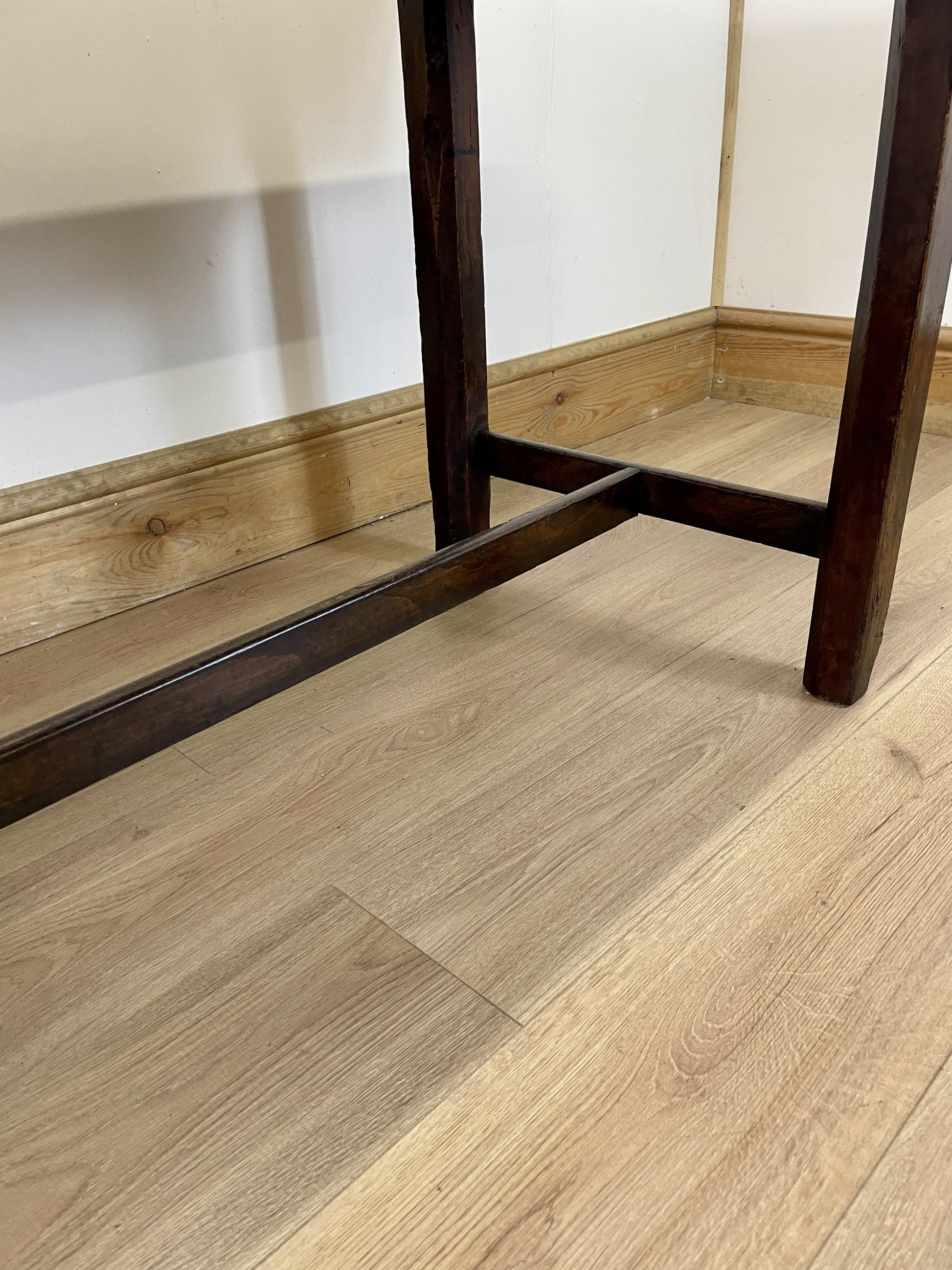 Wooden floor with a piece of furniture partially visible